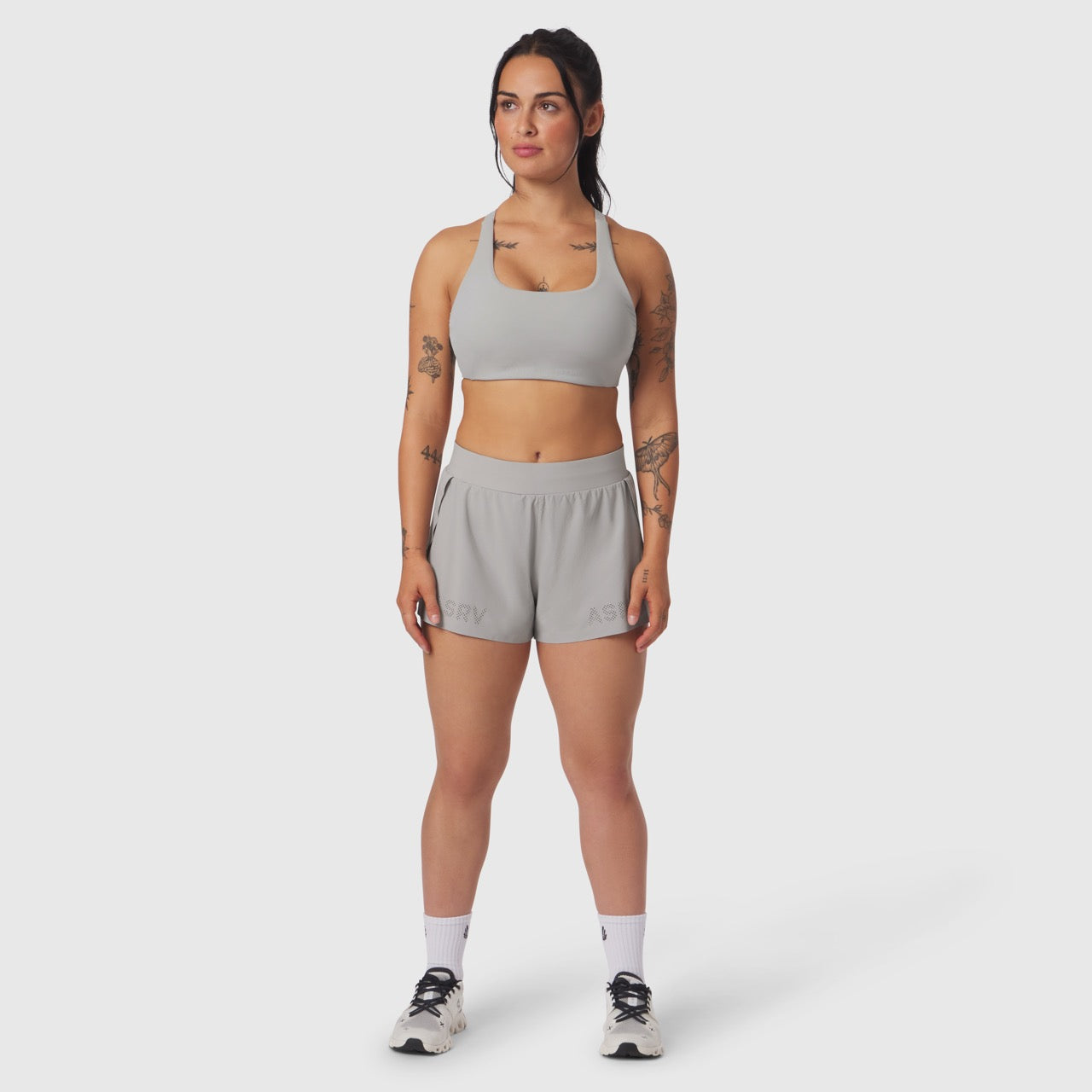 W039 Lycra Hybrid Sports Bra in slate grey, worn by model with matching shorts, front view