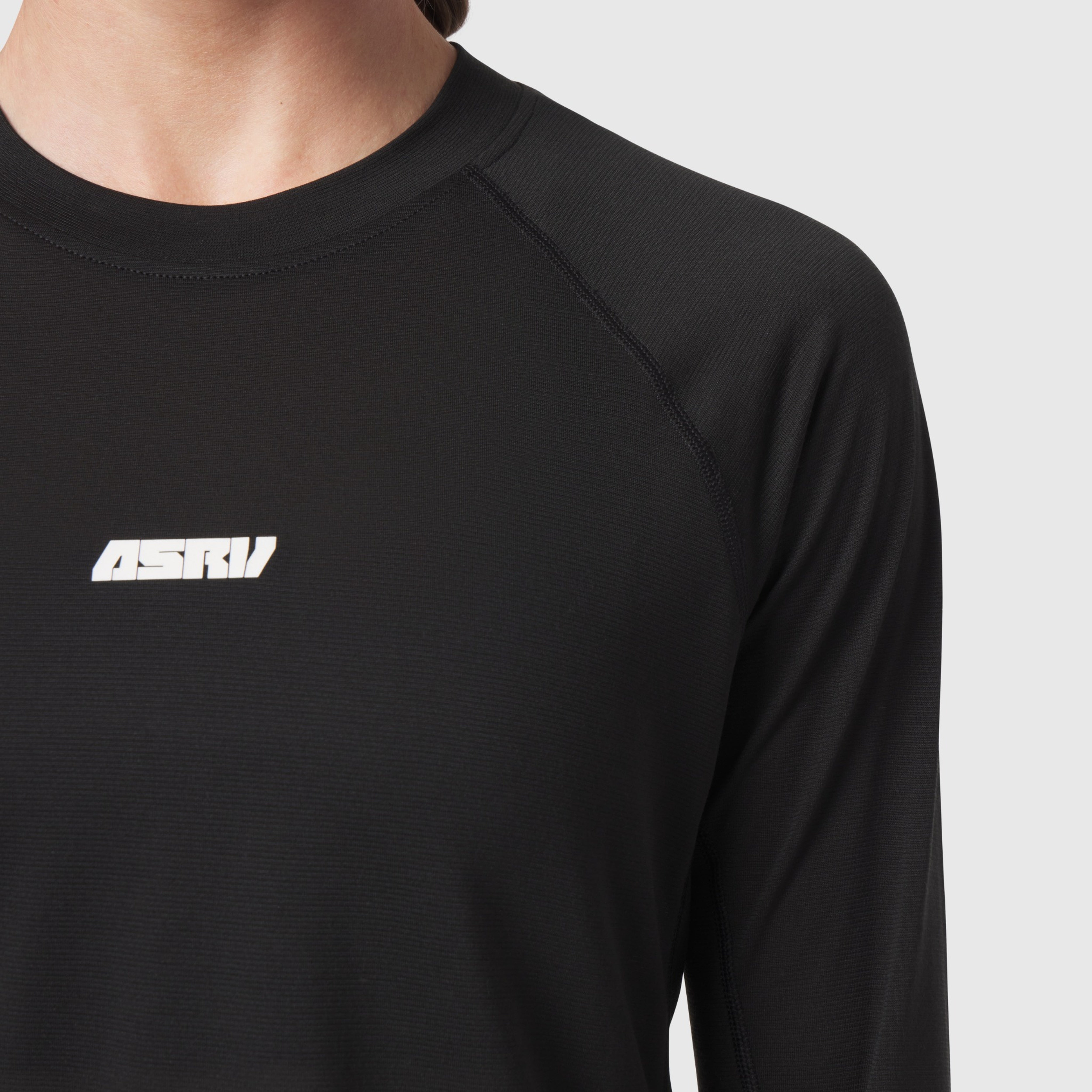 Polartec® Delta Longsleeve in black worn by model, chest detail view