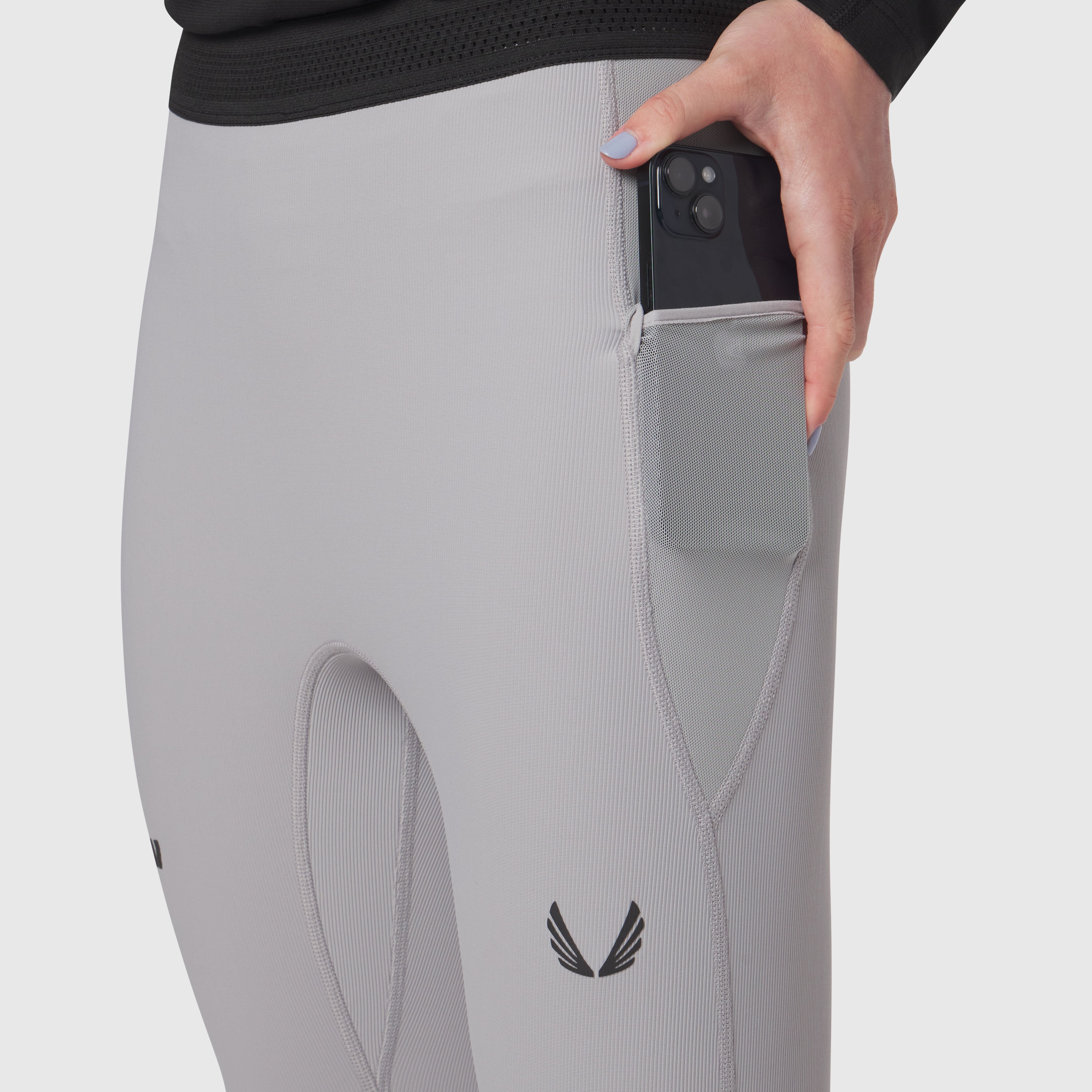Lycra Ribbed Running Tight in slate grey worn by model, showing side pocket detail with phone