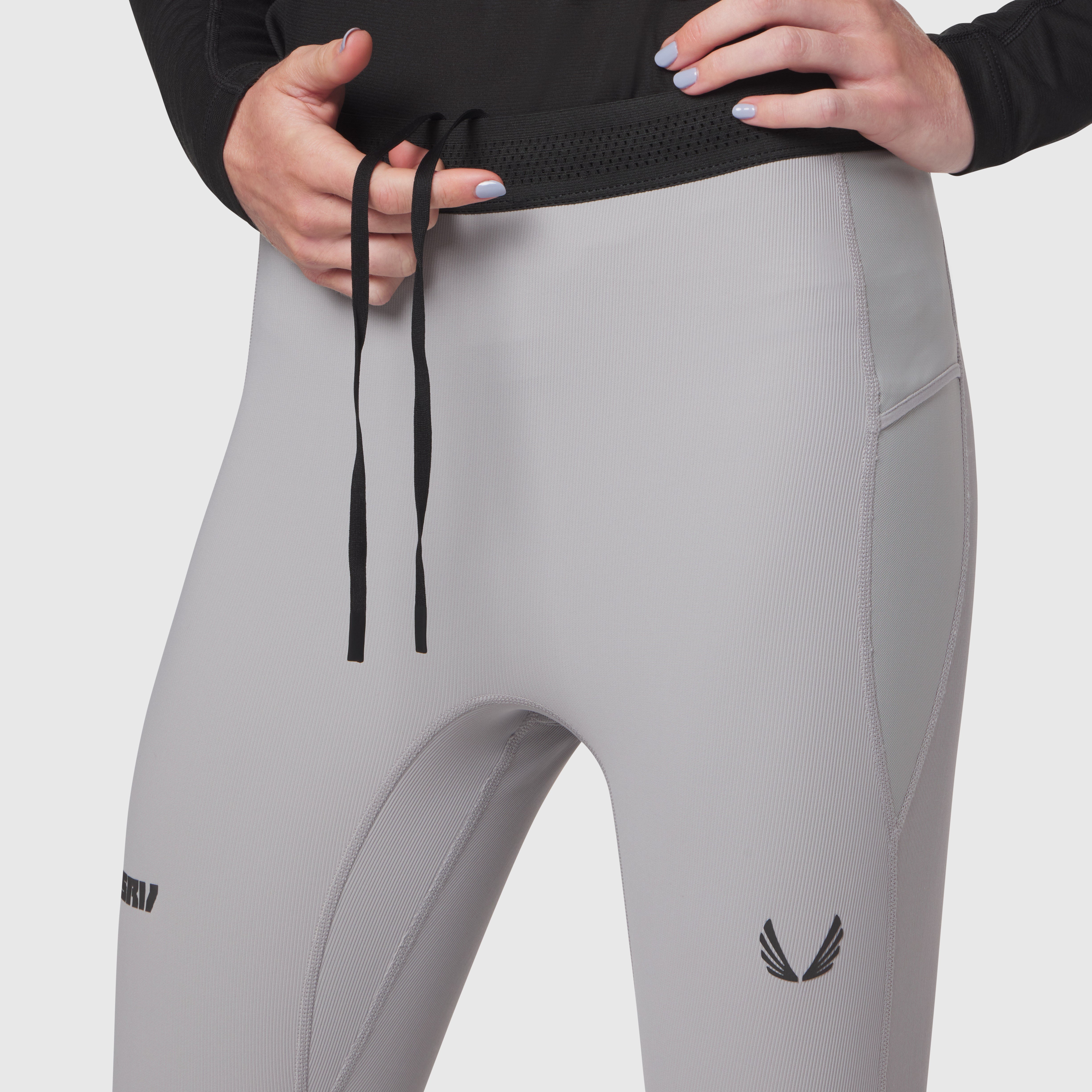 W055 Lycra Ribbed Running Tight in slate grey, model wearing and adjusting waistband