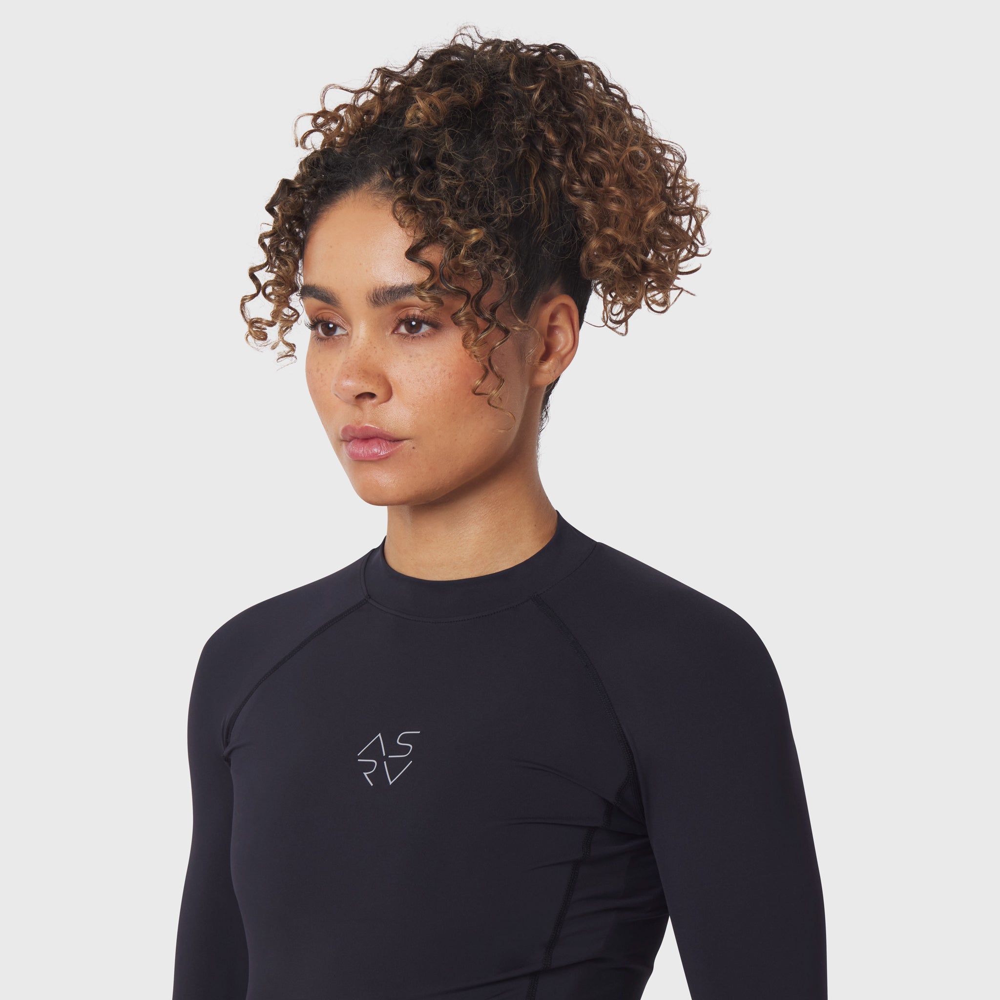 LYCRA® ADAPTIV Baselayer Longsleeve in black, worn by model, front view