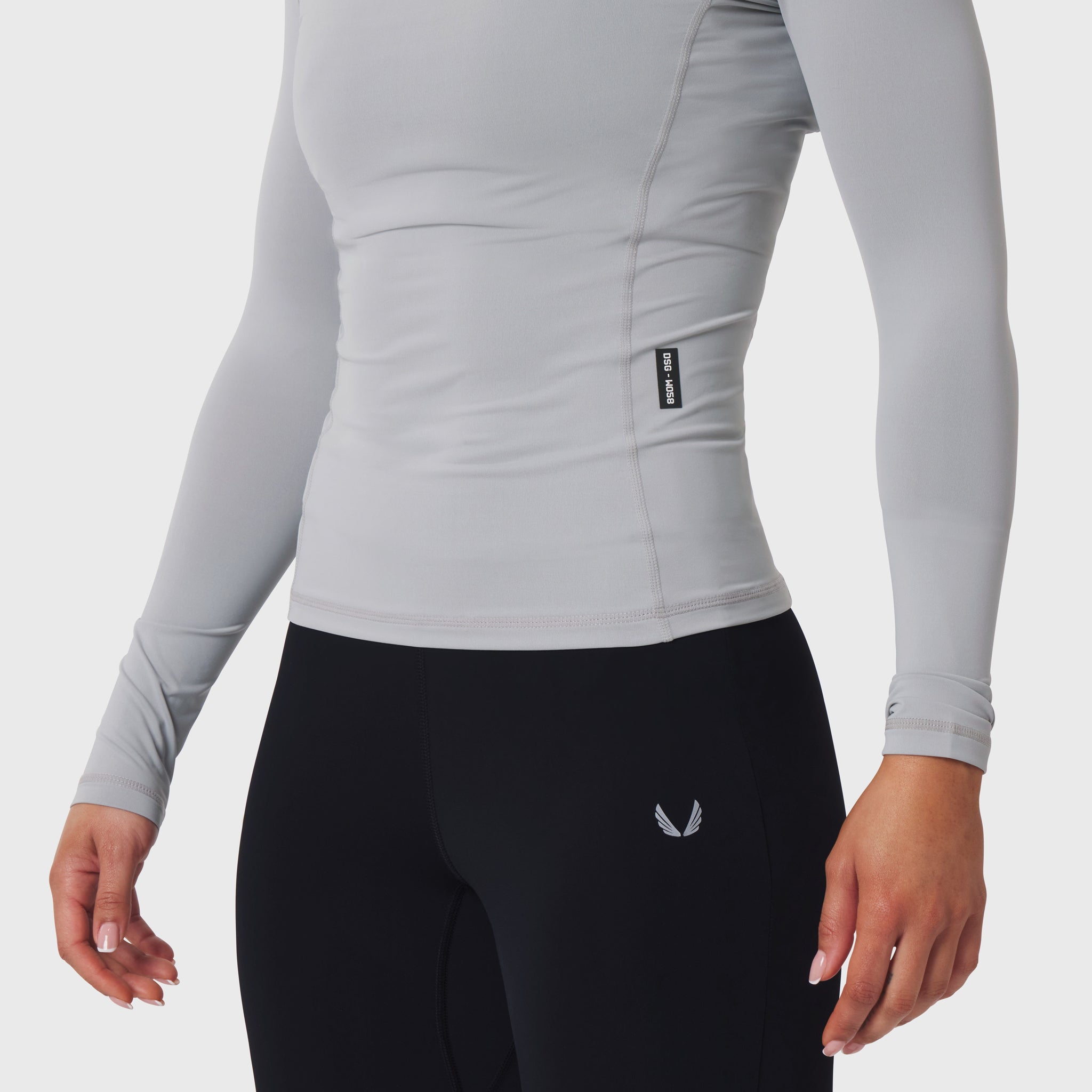 LYCRA® ADAPTIV baselayer longsleeve in slate grey worn with black leggings, side view