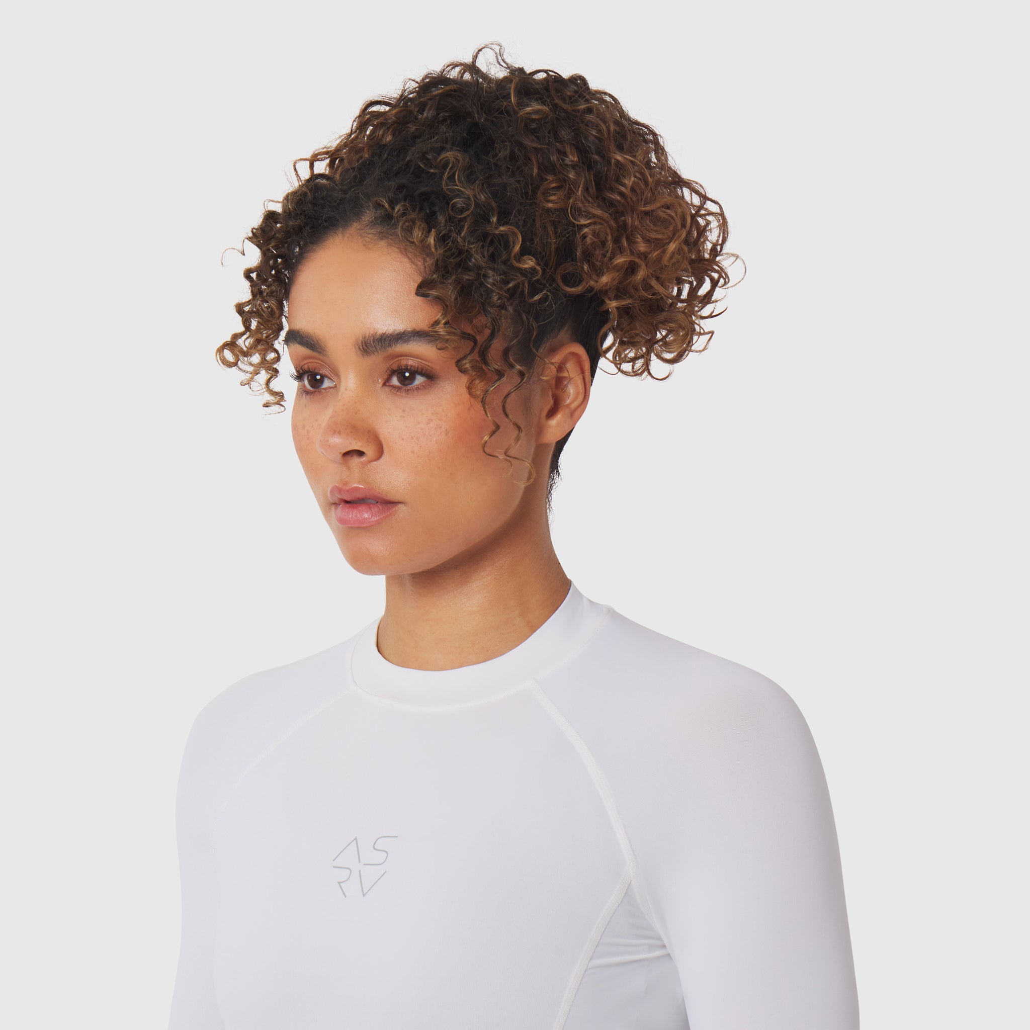 LYCRA® ADAPTIV baselayer longsleeve in white, worn by model, front view