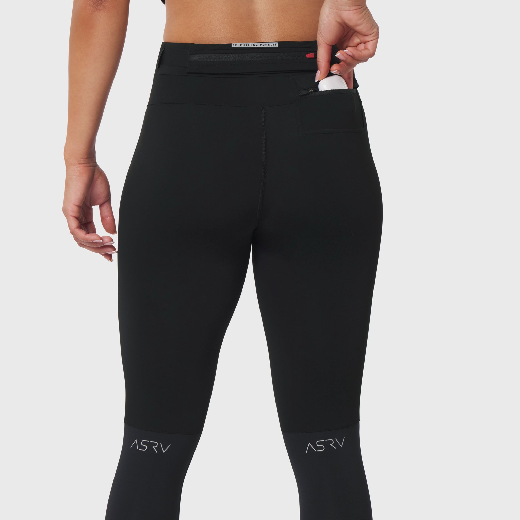 W059 Hybrid Belt-Pack Run Legging in black, worn by model showing side pocket detail