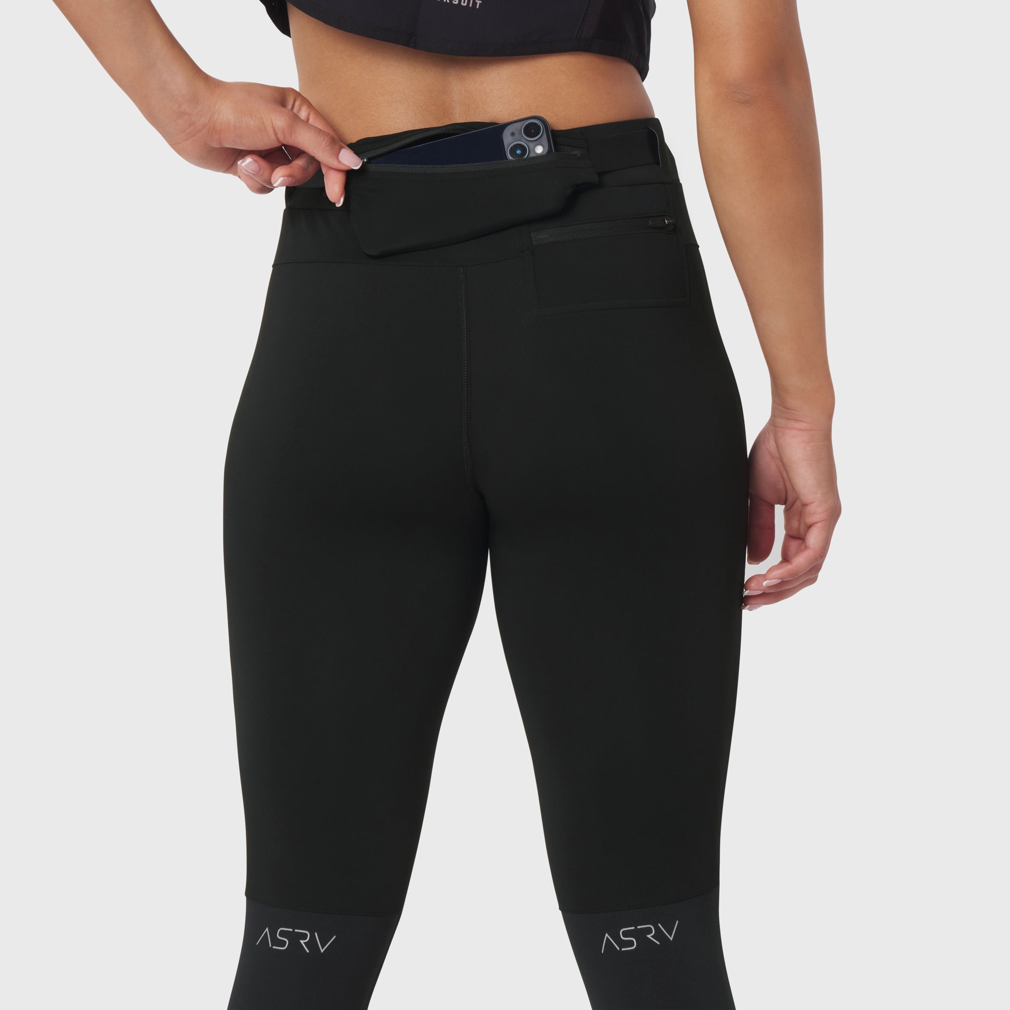W059 Hybrid Belt-Pack Run Legging in black, worn by model showing waistband with phone holder pocket