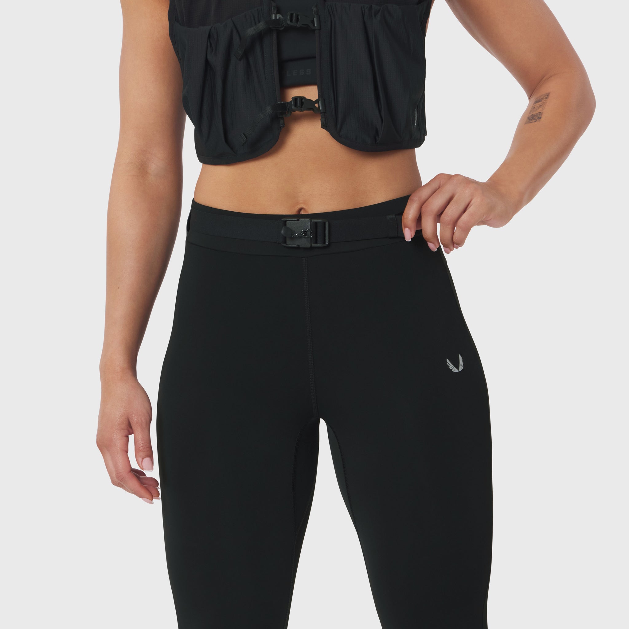 W059 Hybrid Belt-Pack Run Legging in black, worn by model, front view