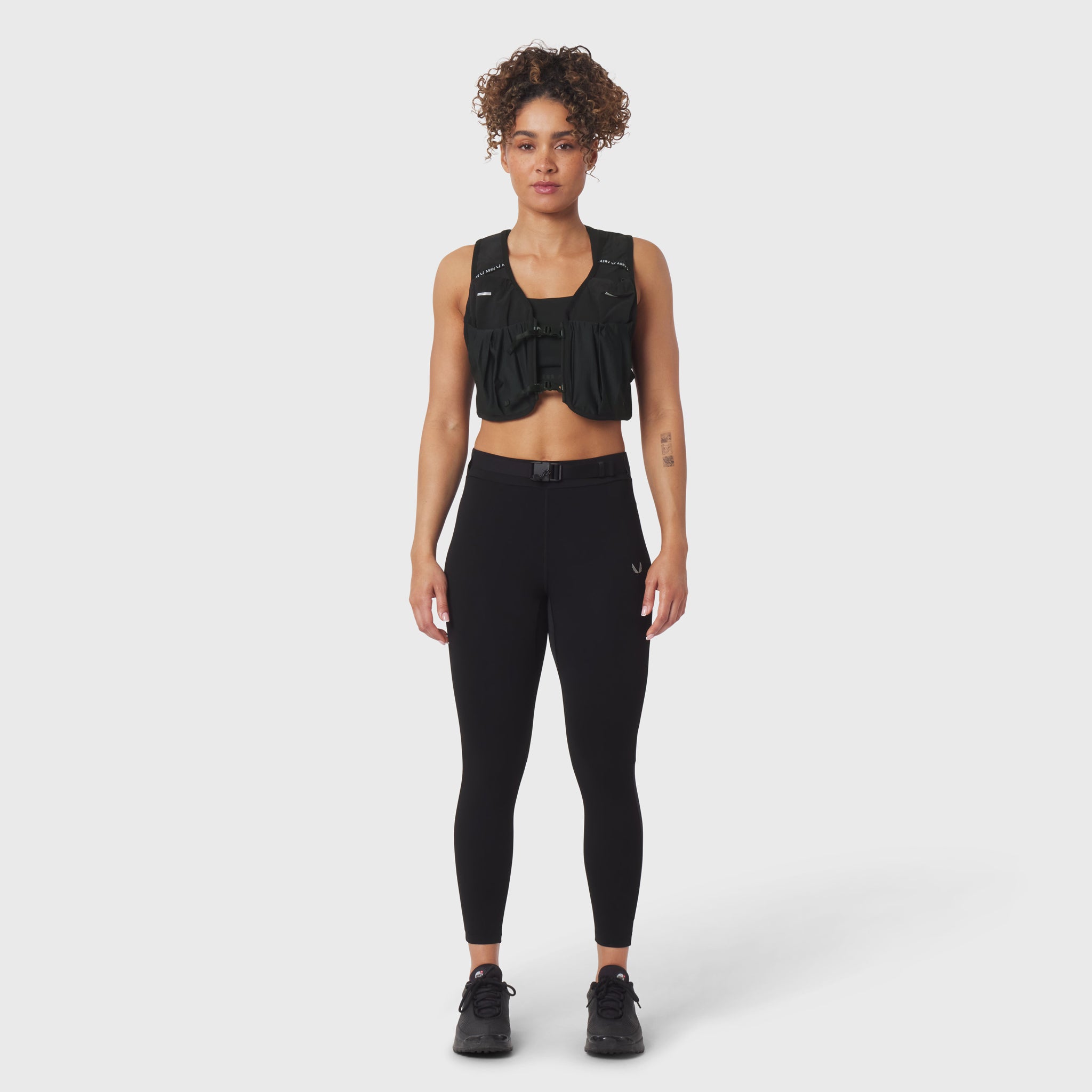 Black hybrid belt-pack run legging on model, front view