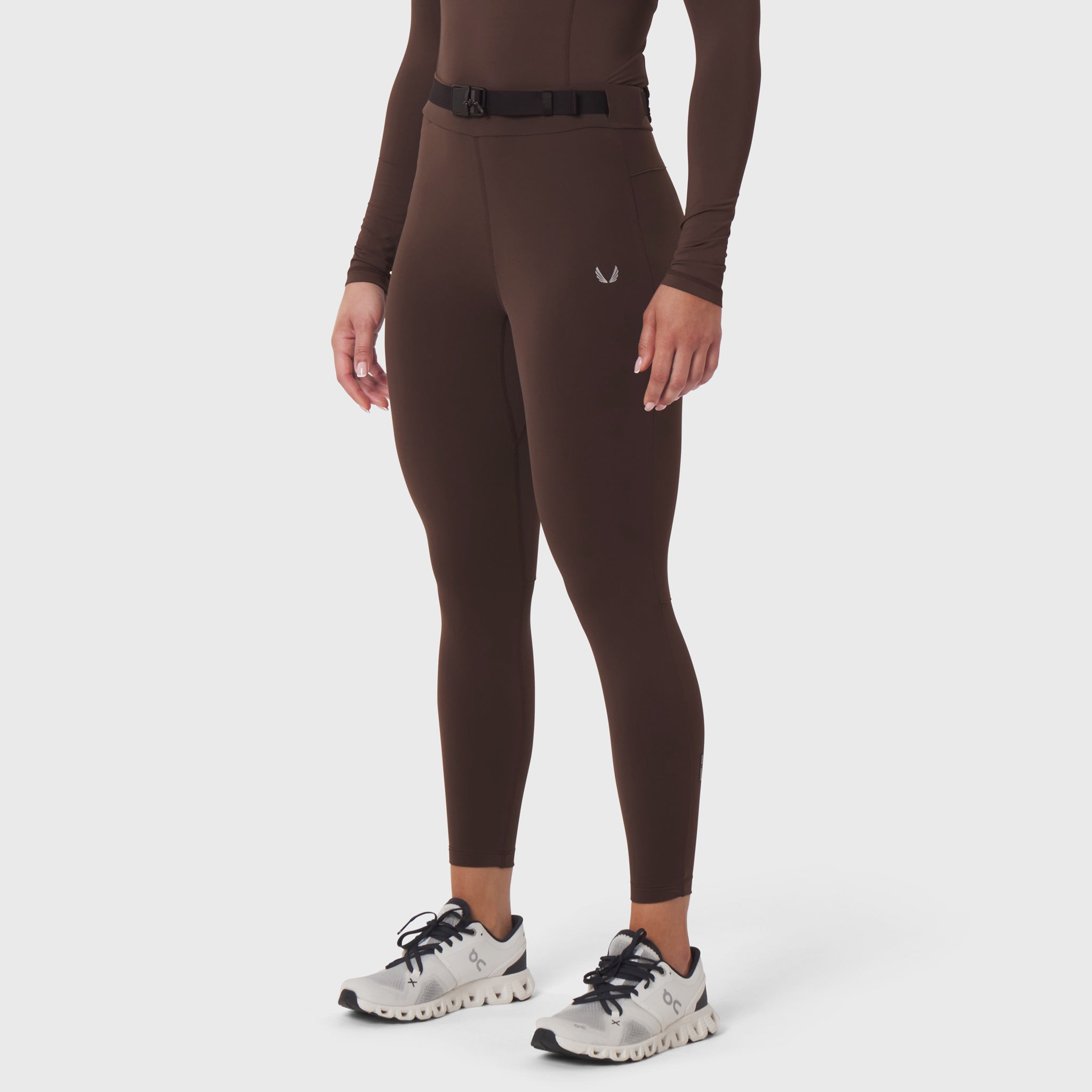 W059 Hybrid Belt-Pack Run Legging in dark earth brown, worn with white sneakers, front view