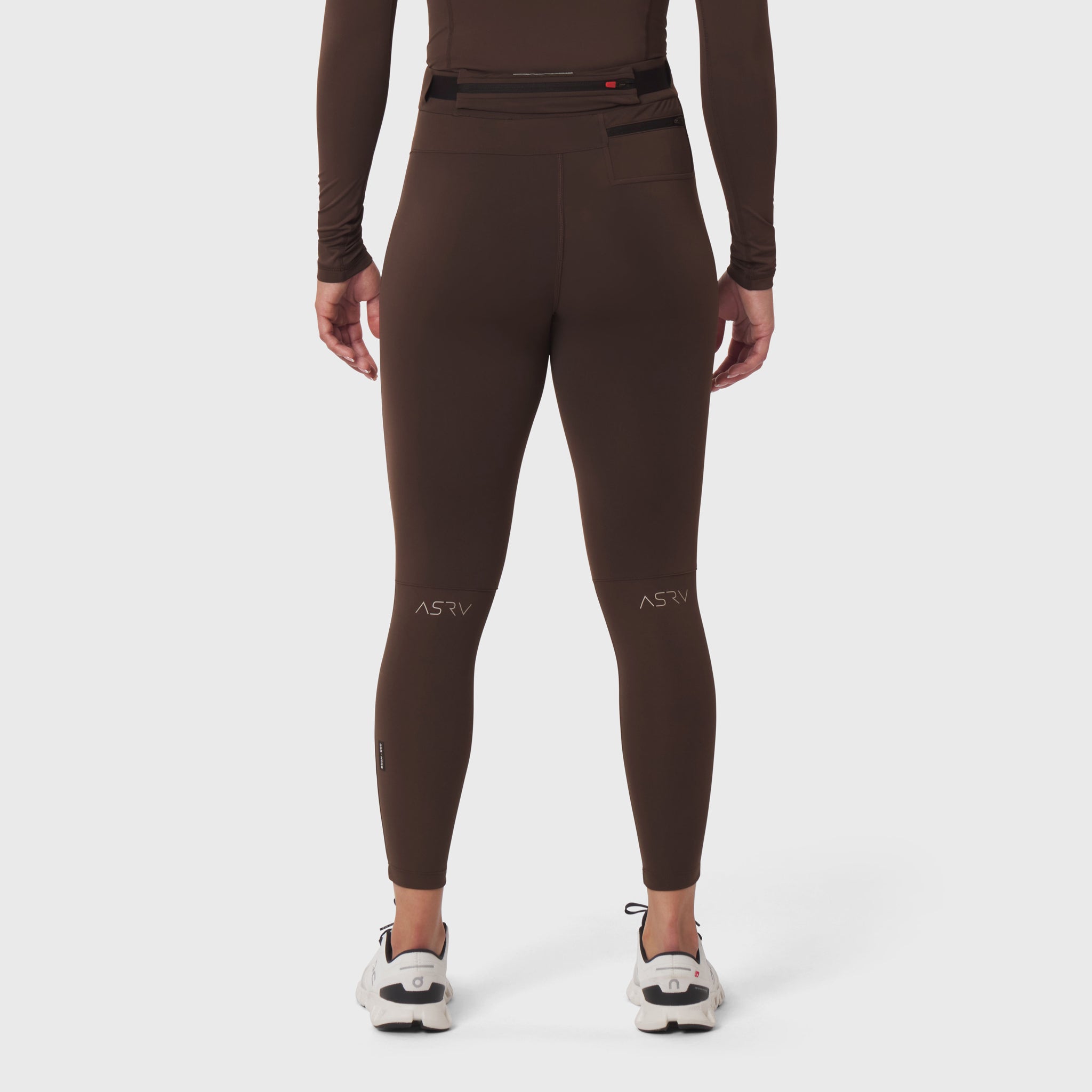 W059 Hybrid Belt-Pack Run Legging in dark earth, back view on model
