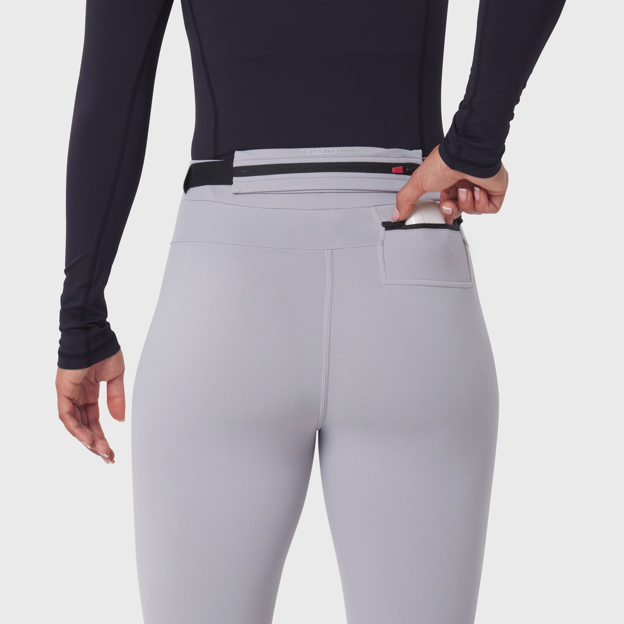 W059 Hybrid Belt-Pack Run Legging in slate grey, back view with model demonstrating belt-pack pocket