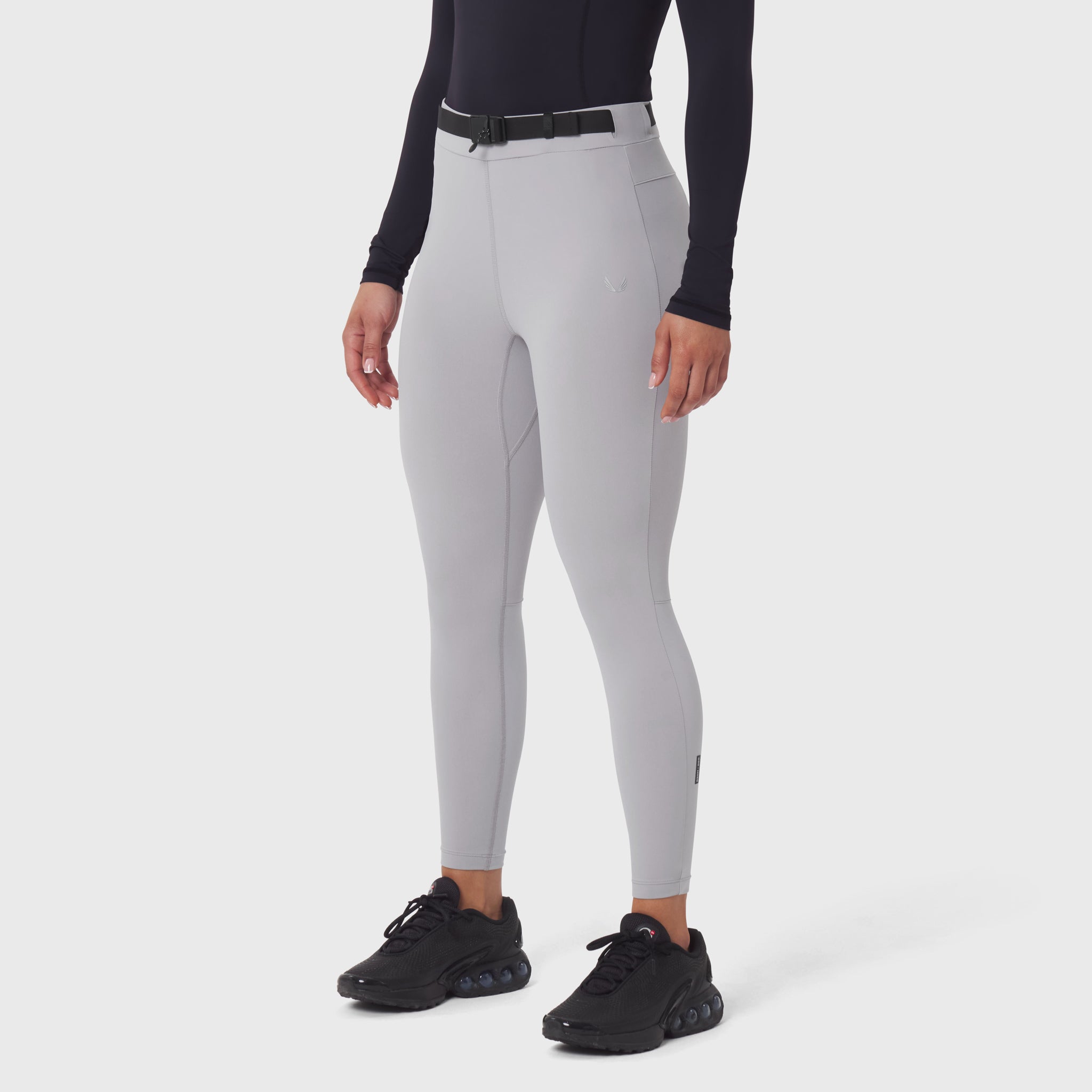 W059 Hybrid Belt-Pack Run Legging in slate grey, modeled from waist down with black sneakers