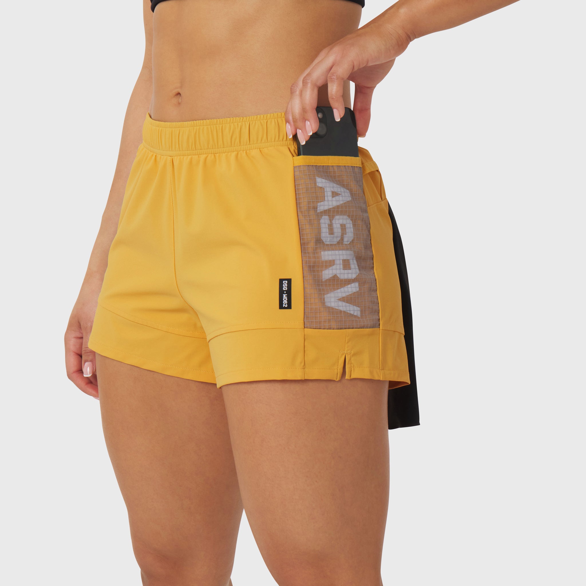 Tetra-Lite Adventure Short in amber yellow, worn by model showing side pocket detail