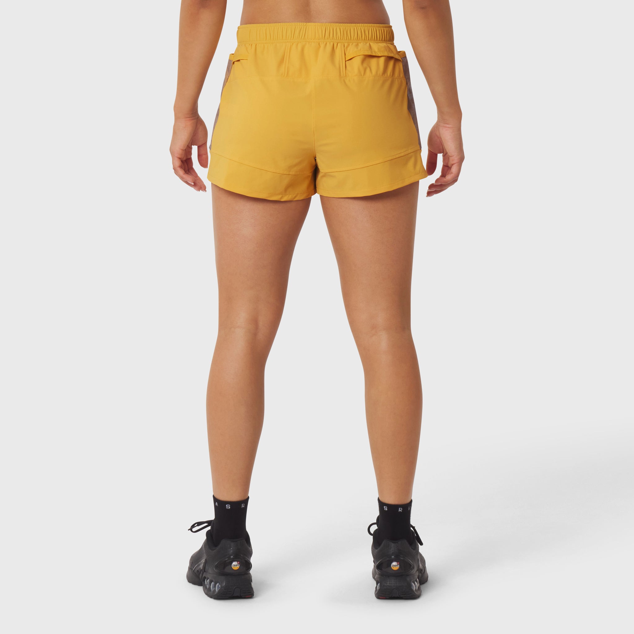 Tetra-Lite Adventure Short in amber, rear view on model wearing black socks and shoes