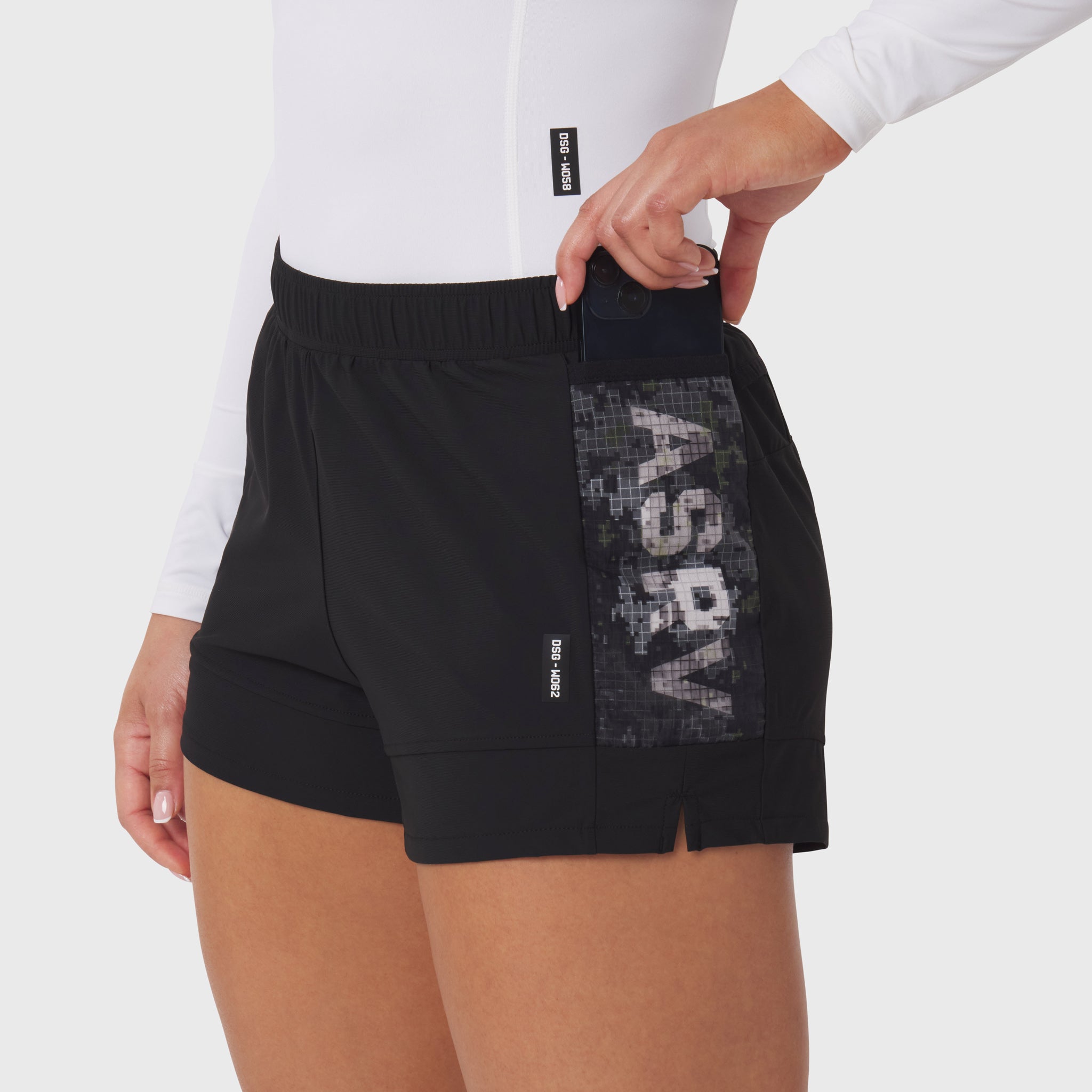 Tetra-Lite Adventure Short in black worn by model, side view showing pocket detail
