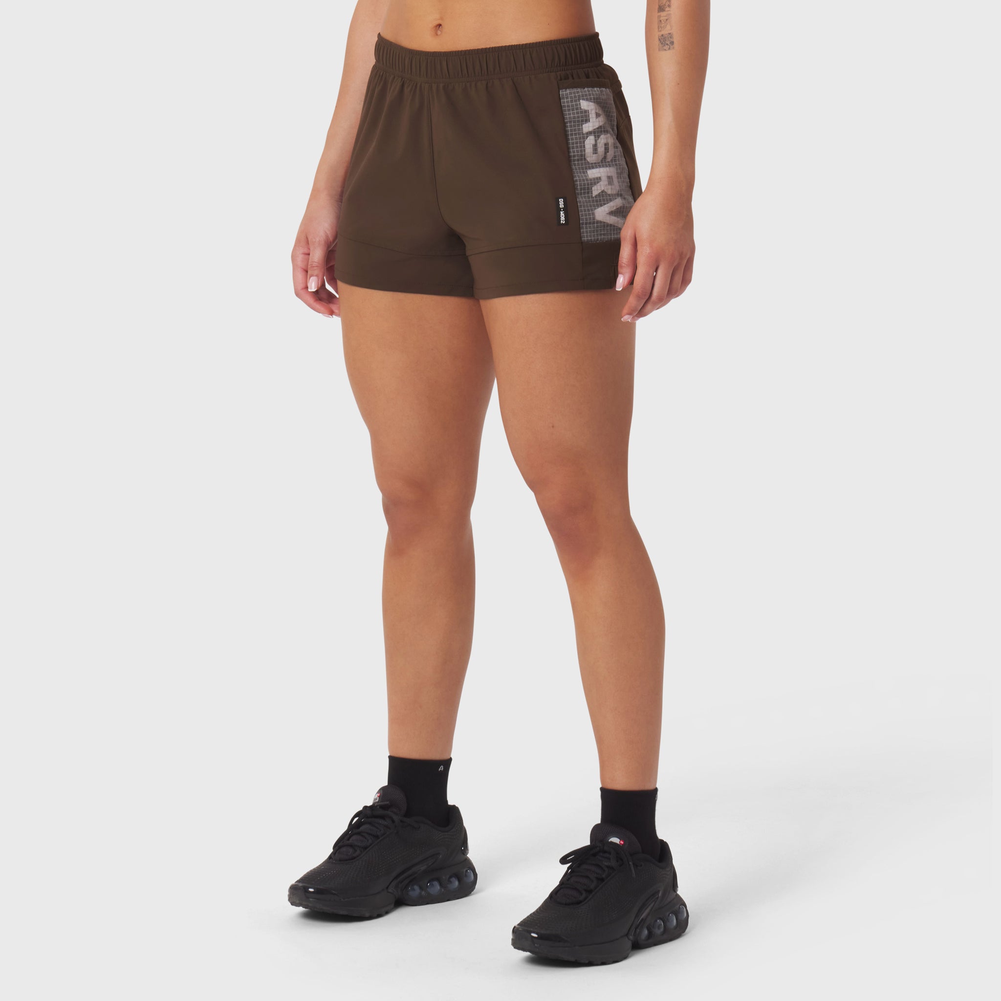W062 Tetra-Lite Adventure Short in dark earth, worn by model with black sneakers