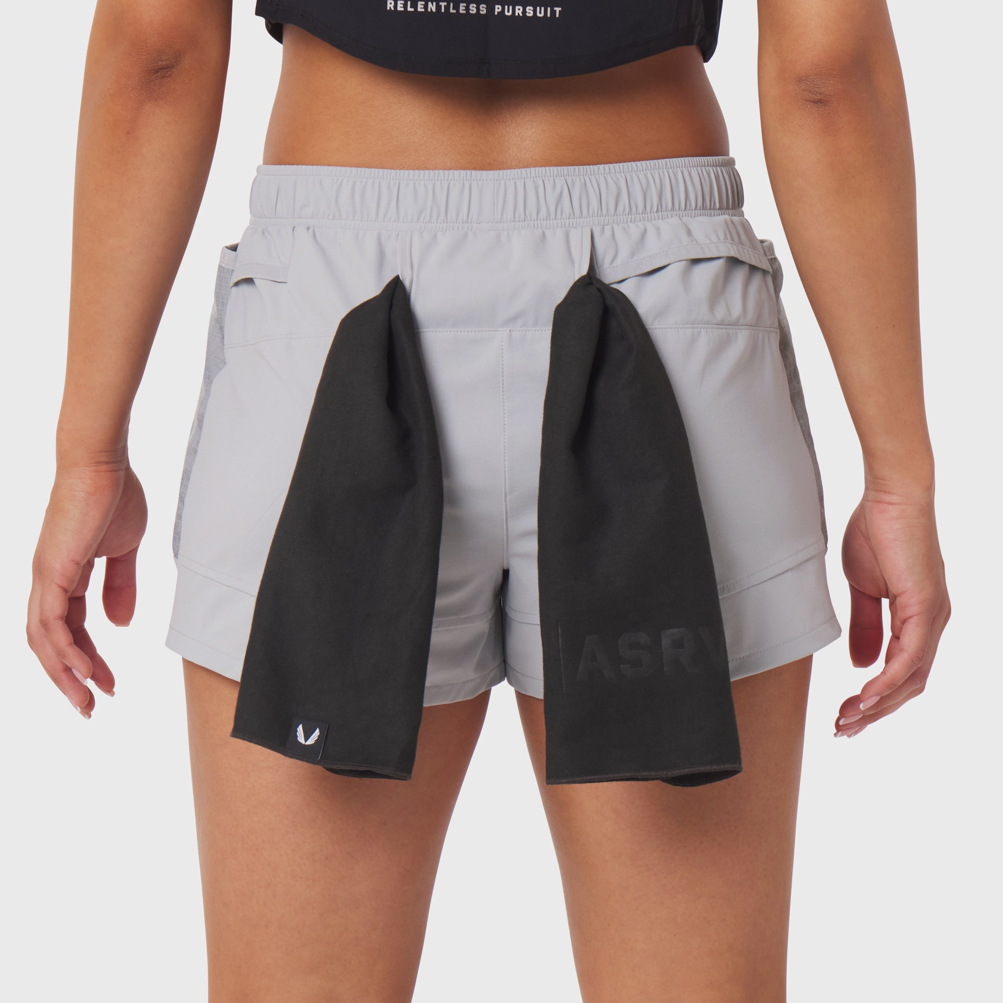 Tetra-Lite Adventure Short in slate grey worn by model, back view with black towel