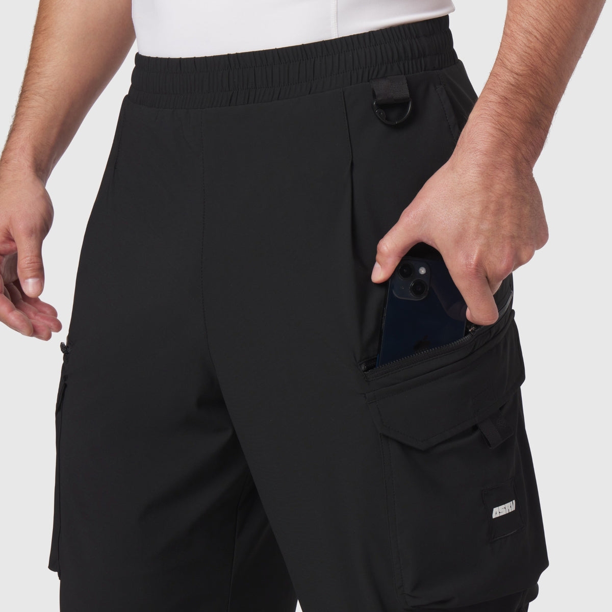 Tetra-Lite® Cargo City Pant in black worn by model, showing cargo pocket detail with phone