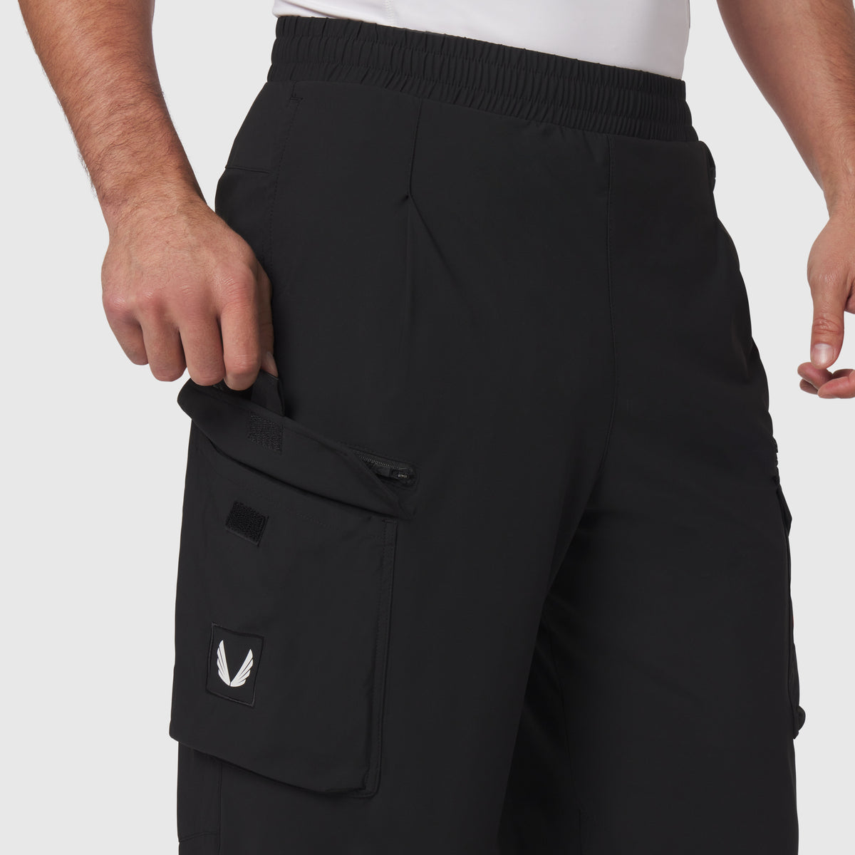 Tetra-Lite® Cargo City Pant in black worn by model, side view showing cargo pocket detail