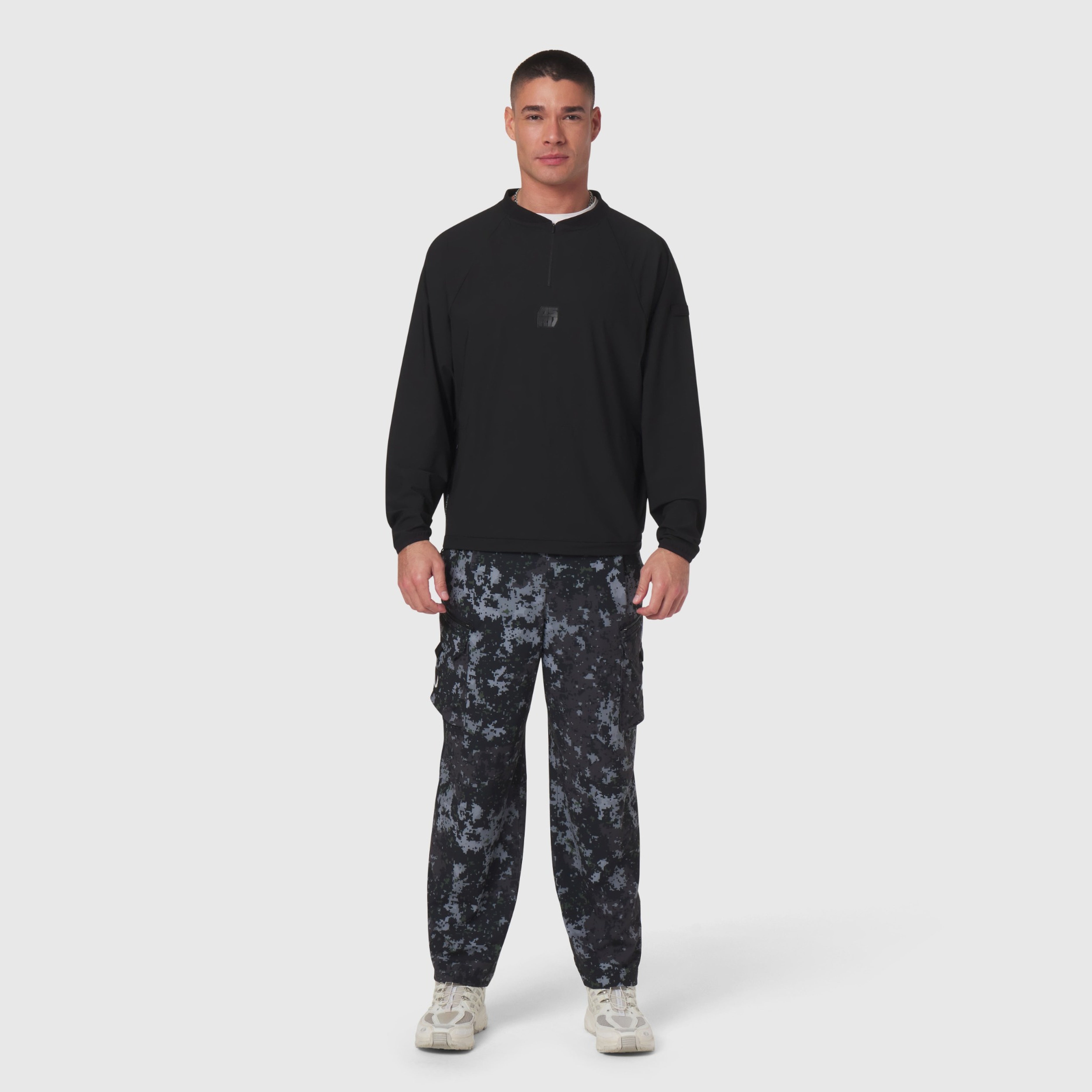 Black Tetra-Lite® Blade Collar Zip Jacket worn with patterned cargo pants, front view on model