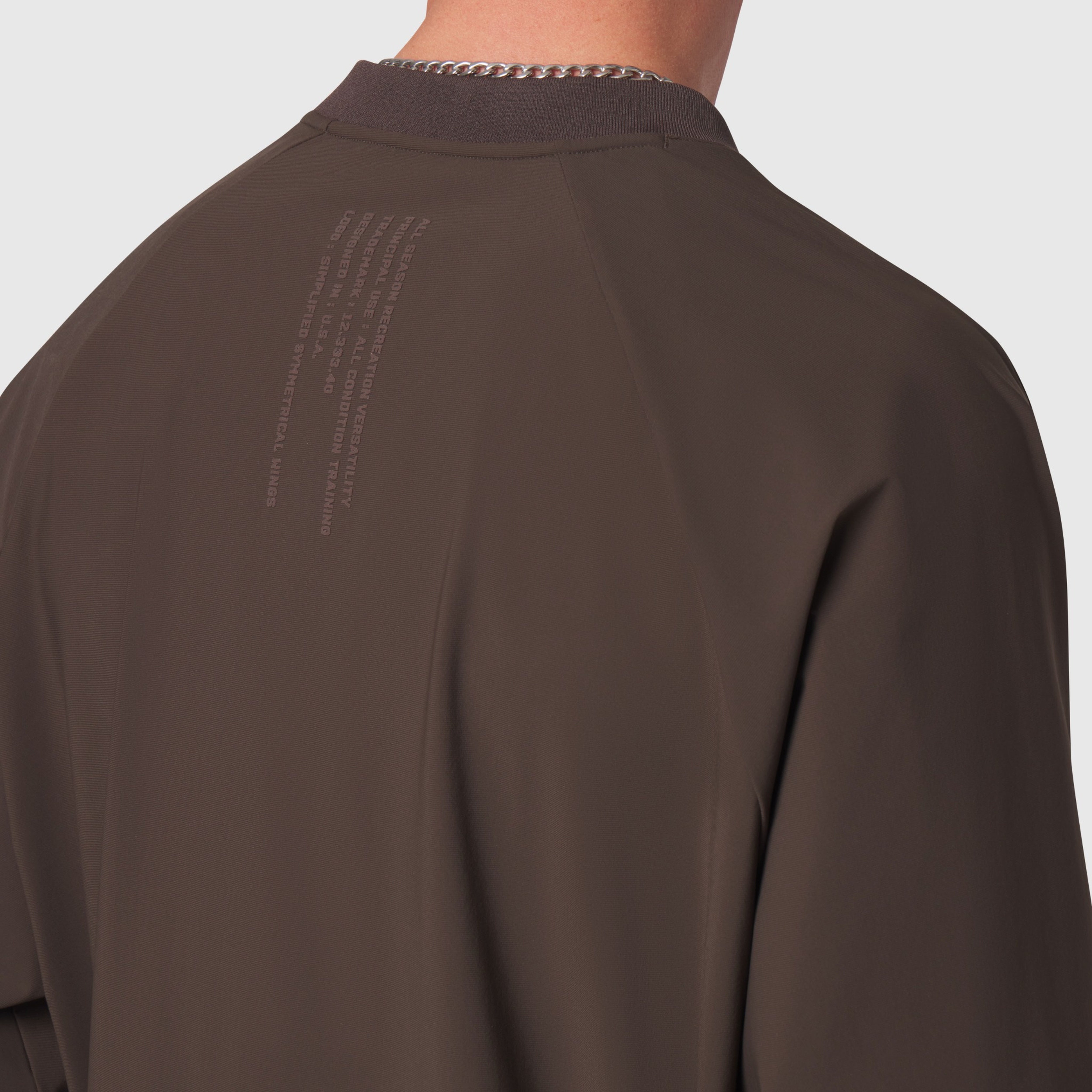 Tetra-Lite Blade Collar Zip Jacket in Dark Earth, back view on model