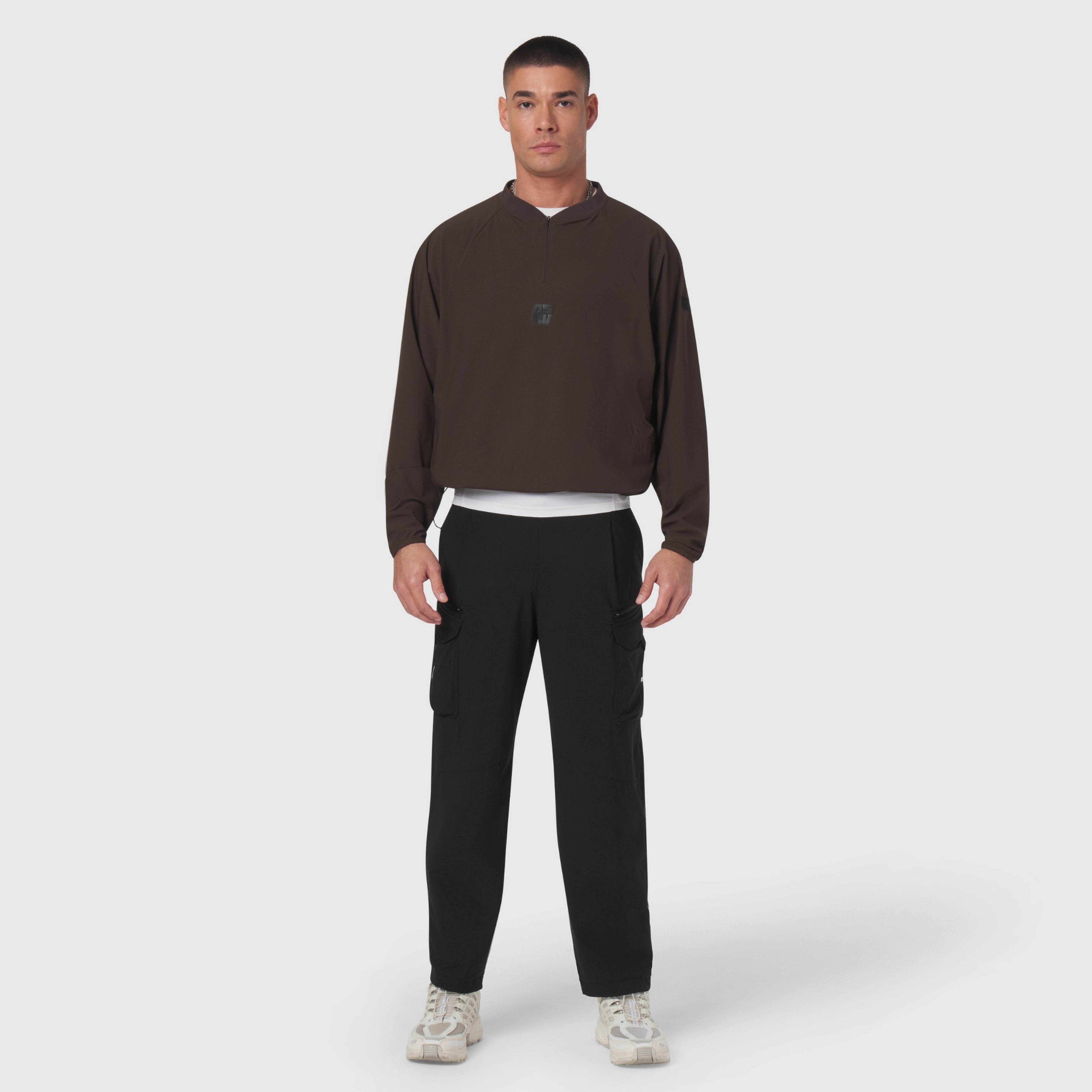 Tetra-Lite® Blade Collar Zip Jacket in dark earth worn with black pants, front view