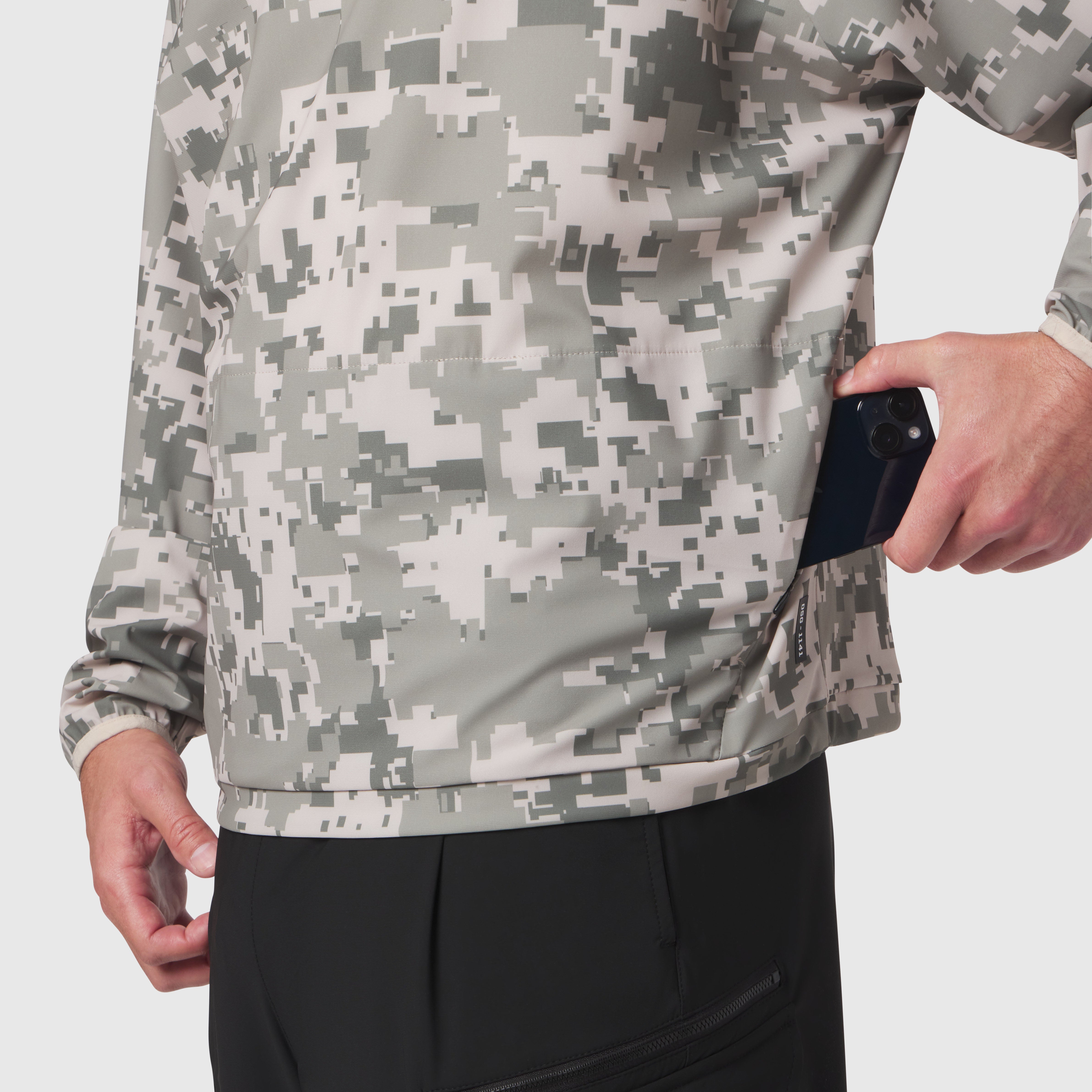 Tetra-Lite Blade Collar Zip Jacket in digital camo, worn by model holding phone