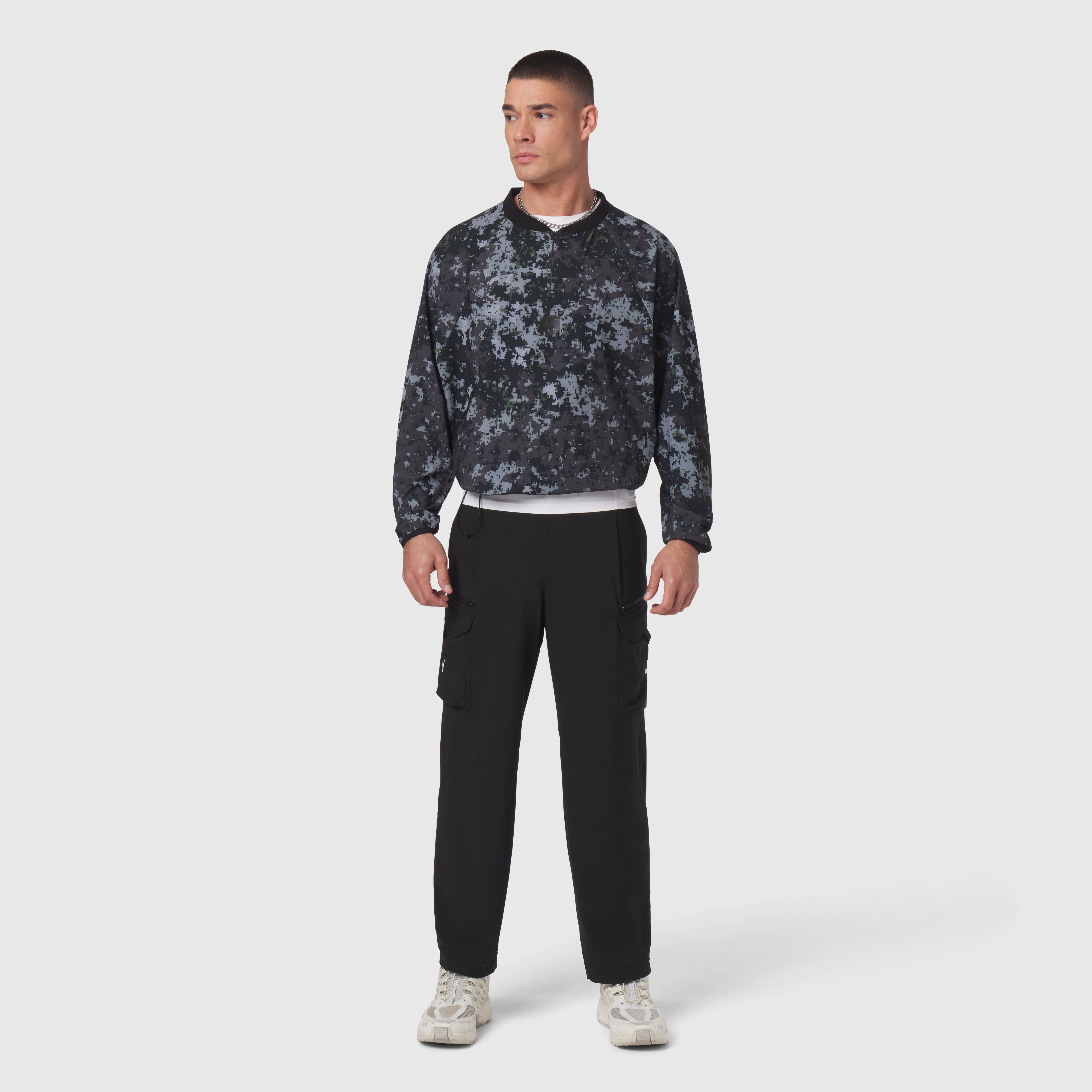 Tetra-Lite Blade Collar Zip Jacket in pixel camo worn with black cargo pants, front view