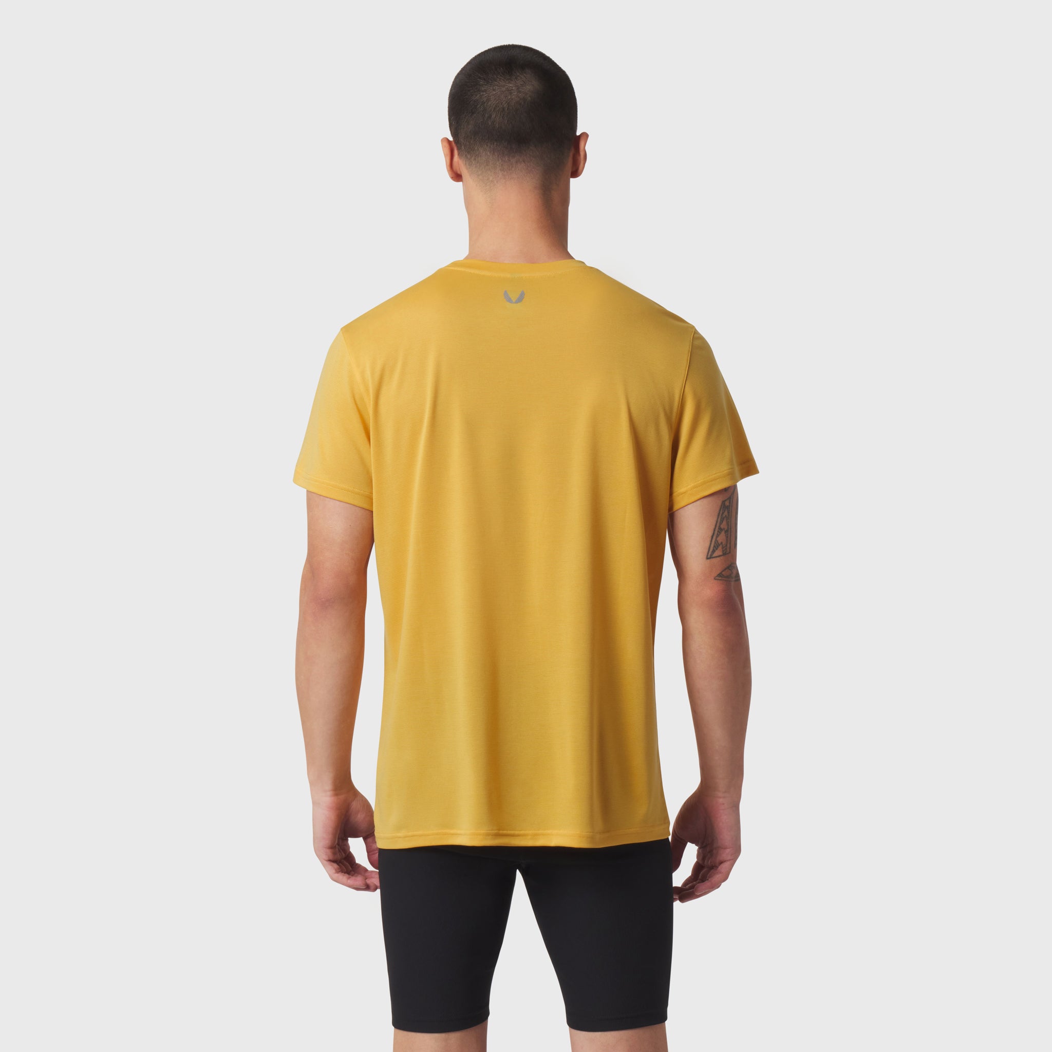 Polartec® Delta Training Tee in amber, rear view on model