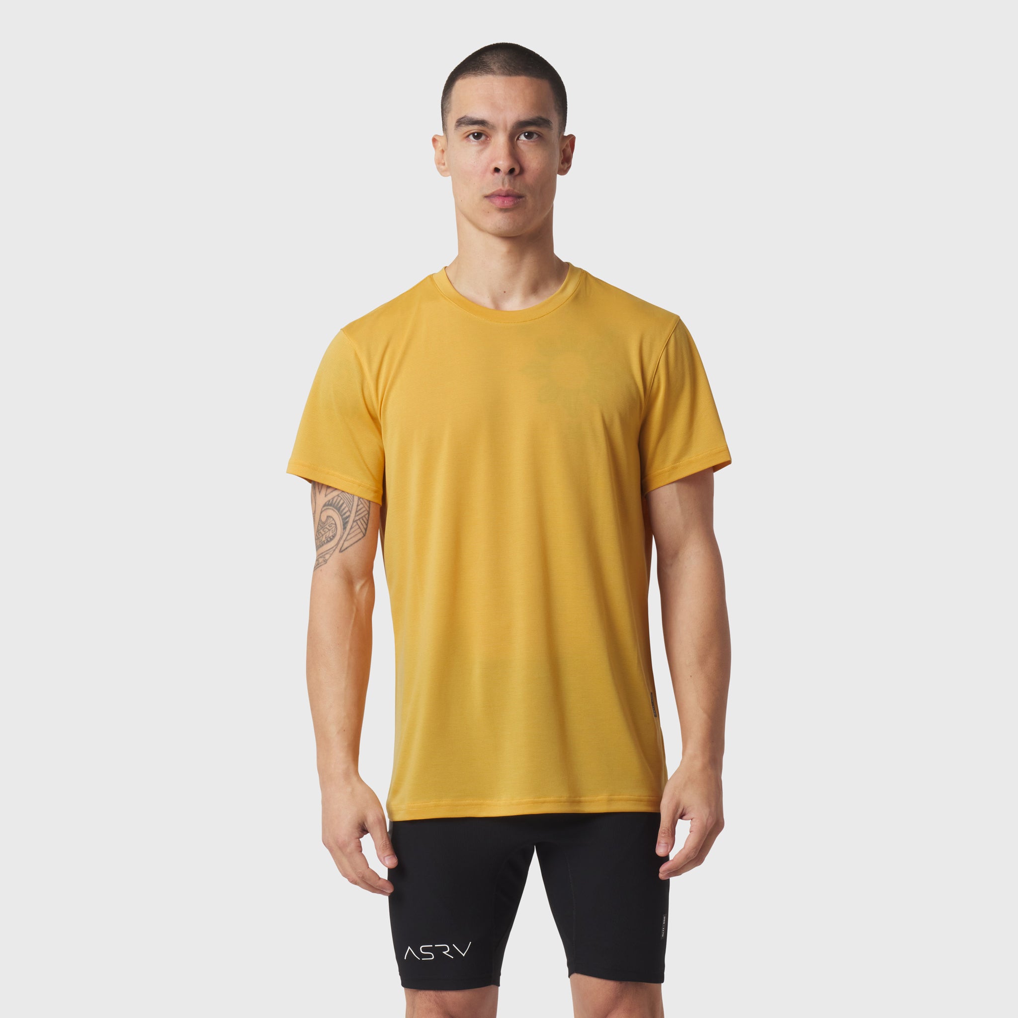 Polartec® Delta Training Tee in amber worn by model with black shorts, front view