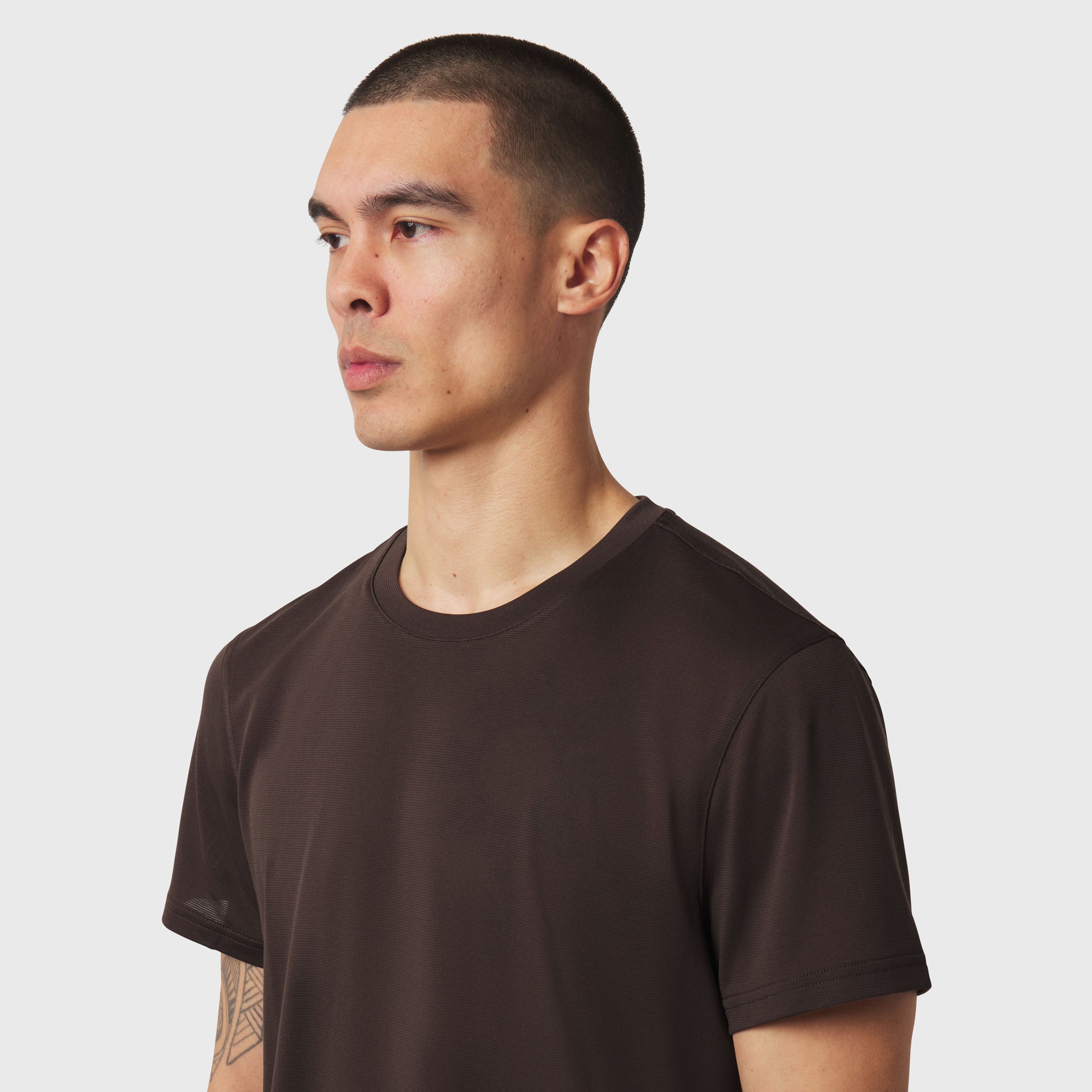 Polartec® Delta Training Tee in dark earth, worn by model in profile view