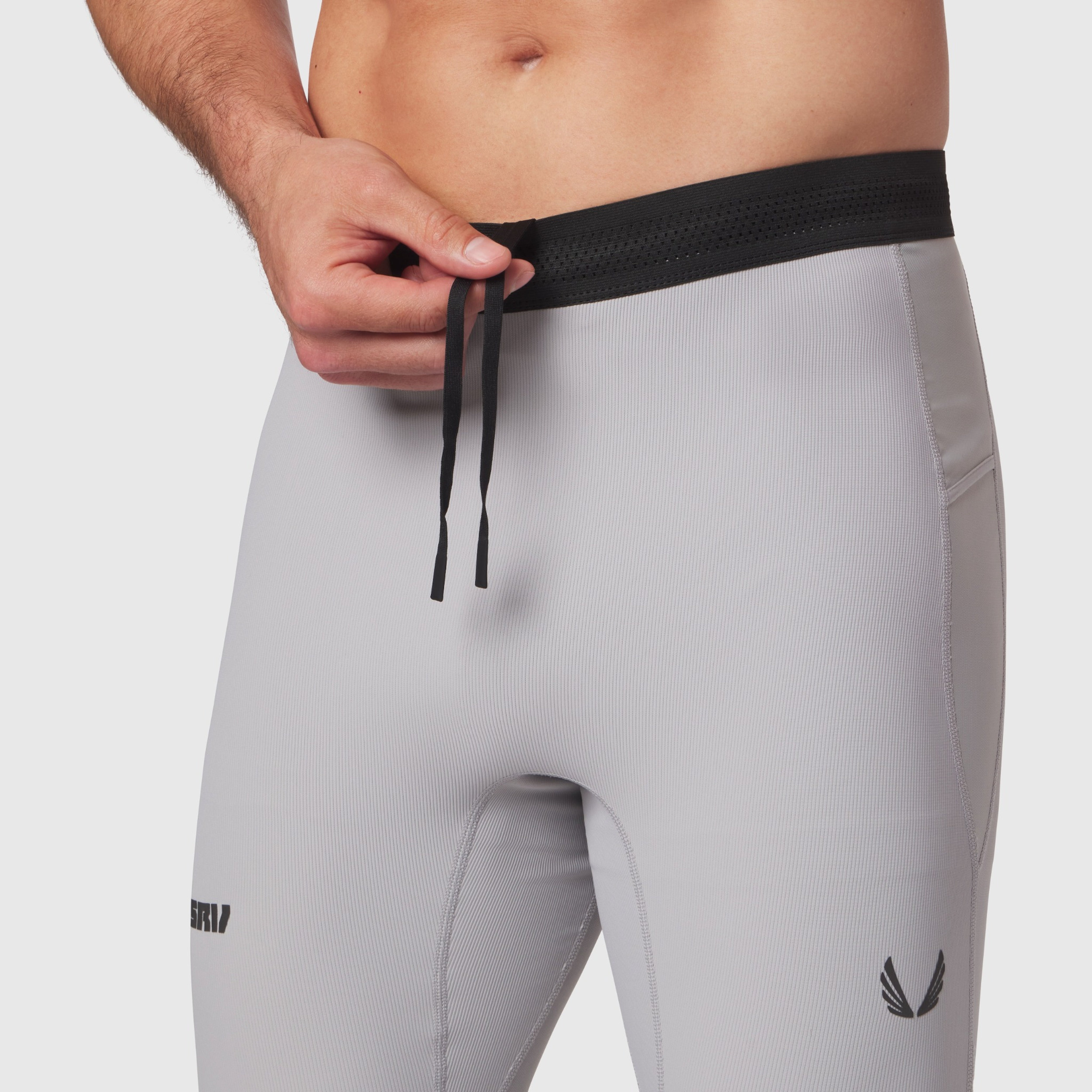 Lycra® Ribbed Running Tight in slate grey worn by model, waistband detail with drawstring