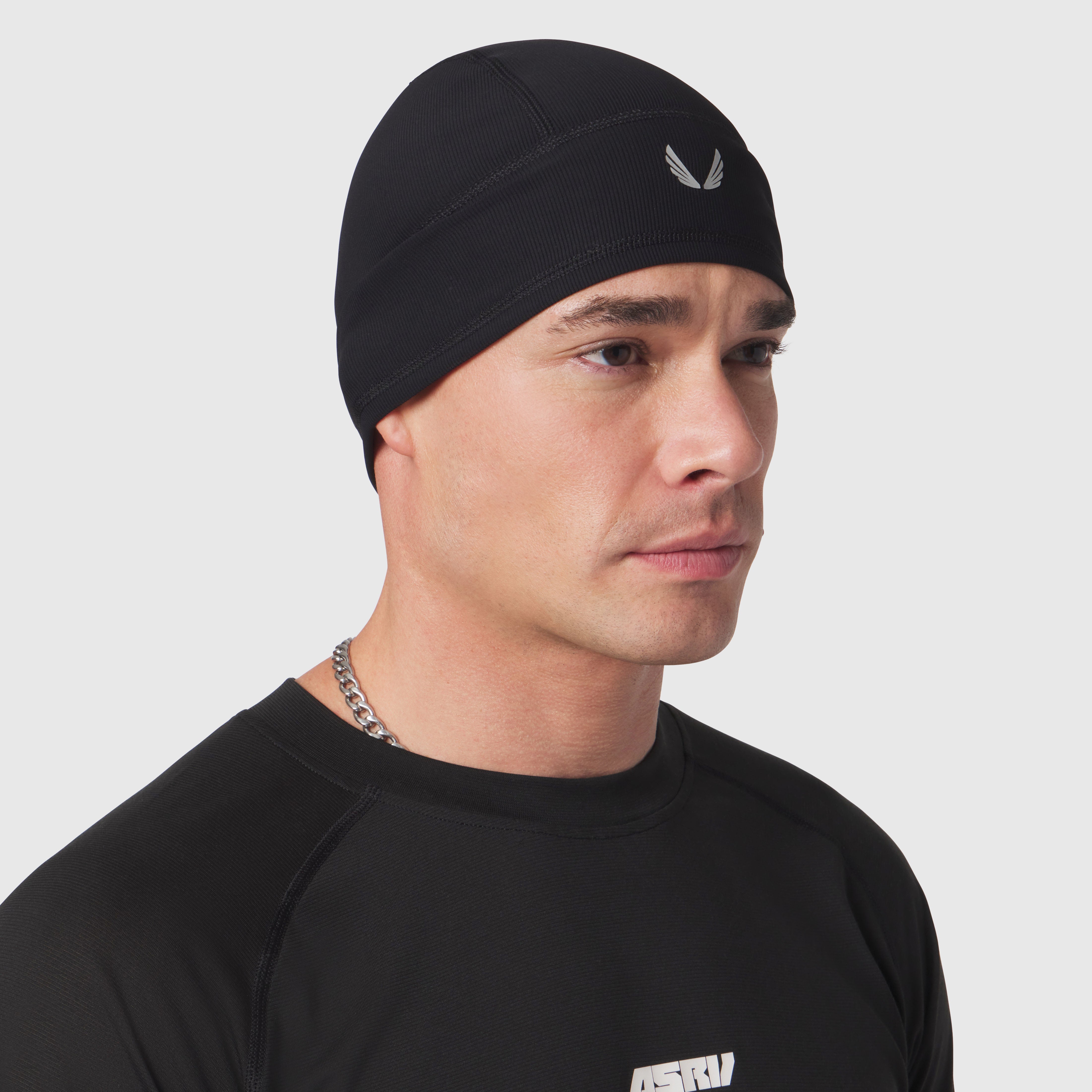 Black Lycra Skully beanie worn by model, side profile view