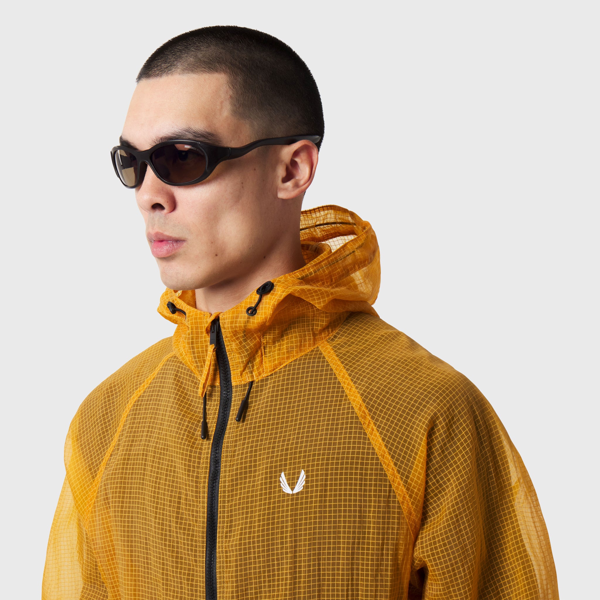 Weather-Ready Transparent Ripstop Shell Jacket in amber, worn by model in profile view