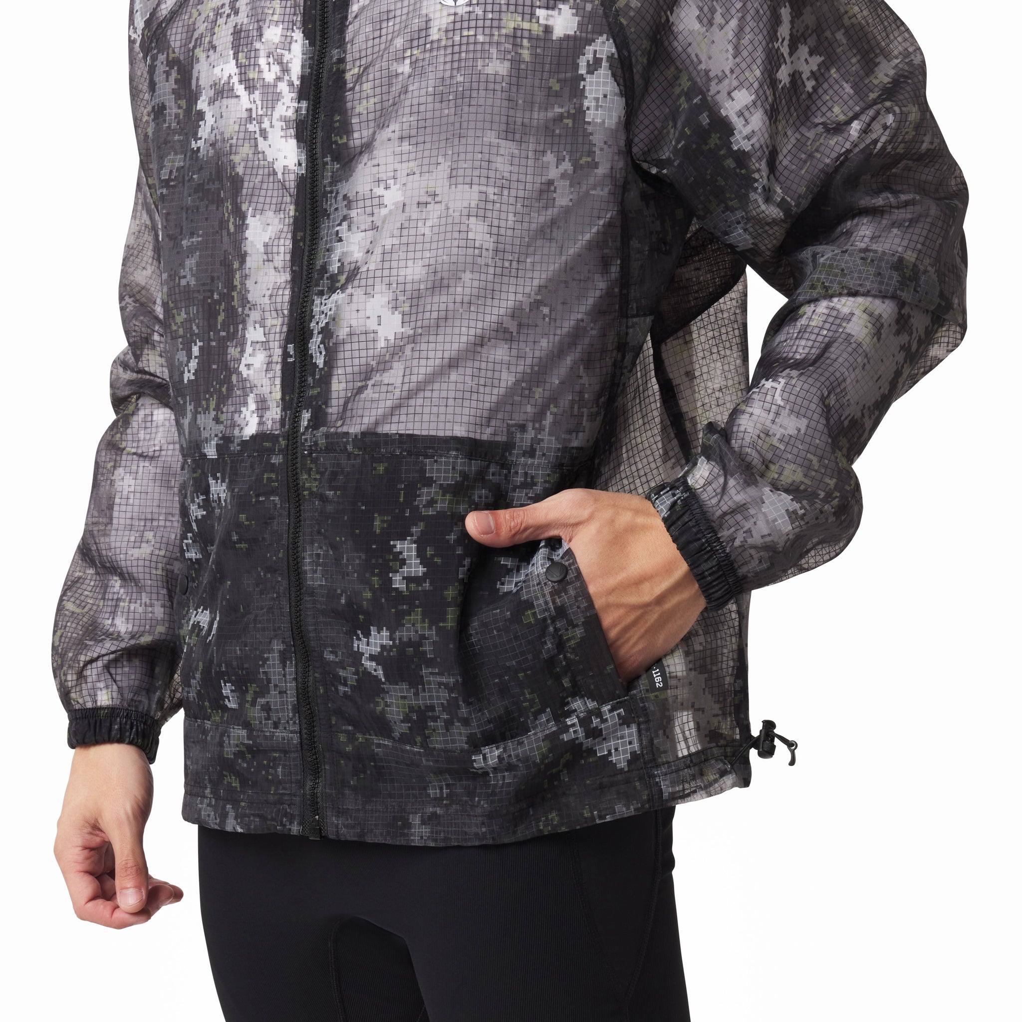 Weather-Ready Transparent Ripstop Shell Jacket in pixel camo, worn by model showing front pocket detail