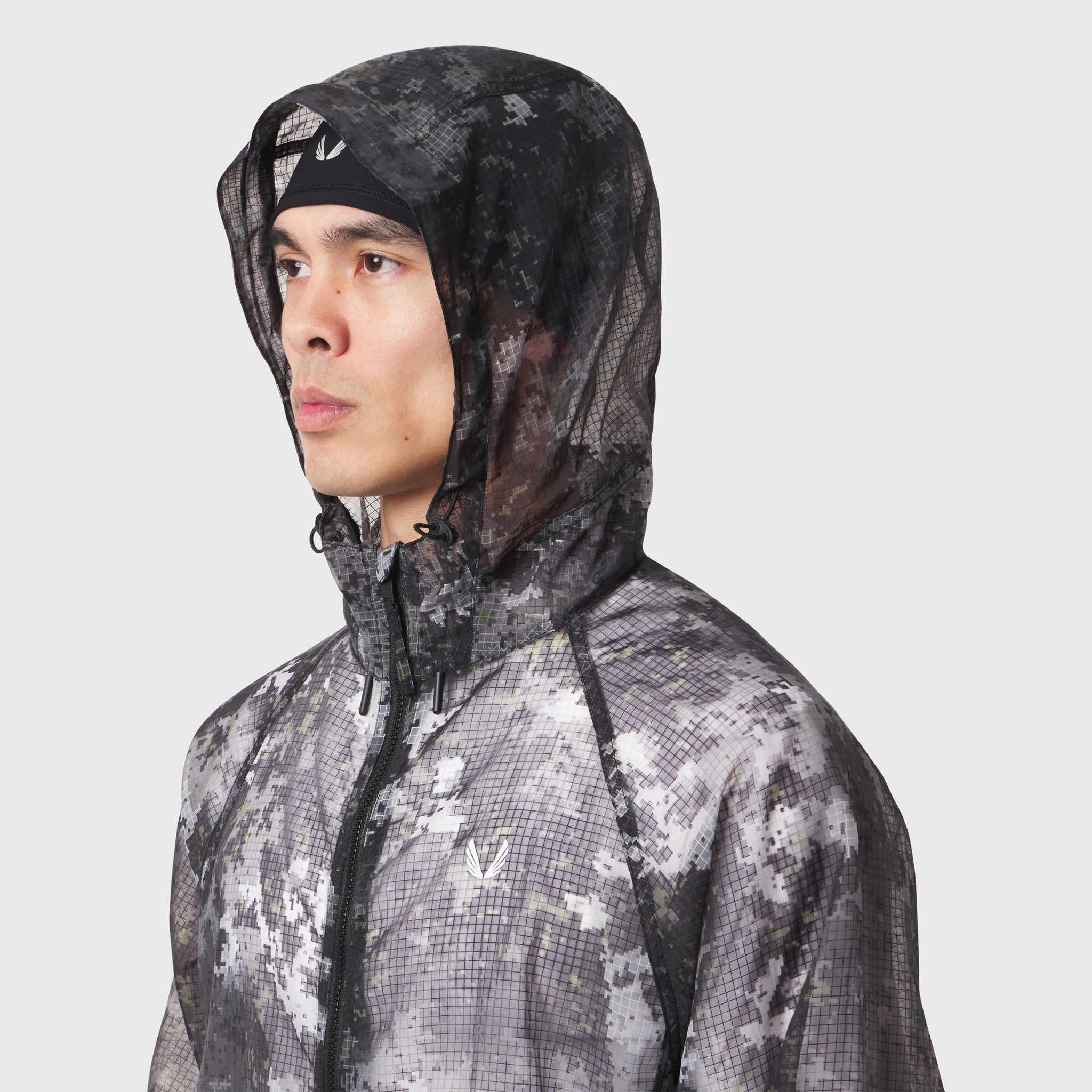 Weather-Ready Transparent Ripstop Shell Jacket in pixel camo, worn by model in profile view