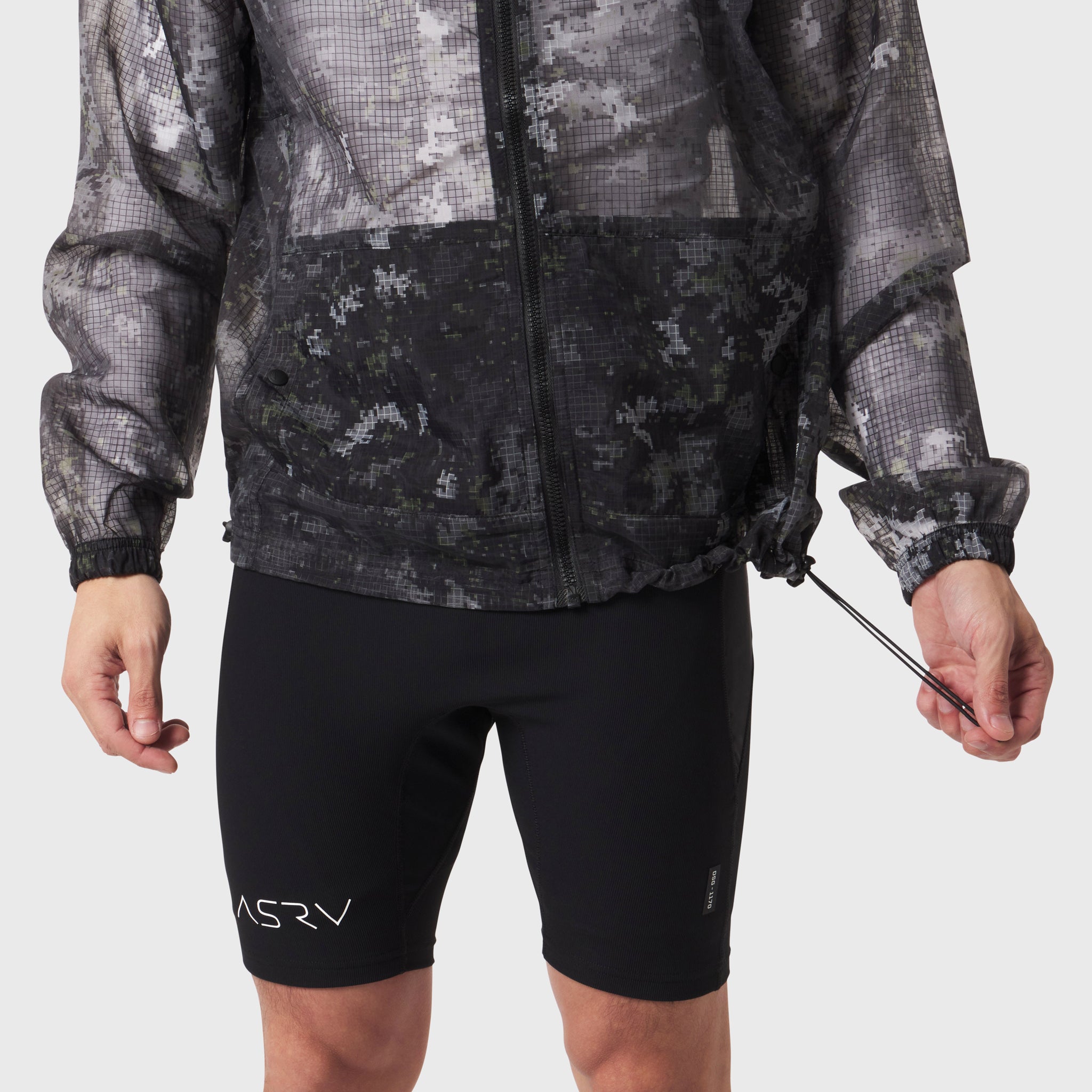 Weather-Ready Transparent Ripstop Shell Jacket in pixel camo worn with black shorts, front view