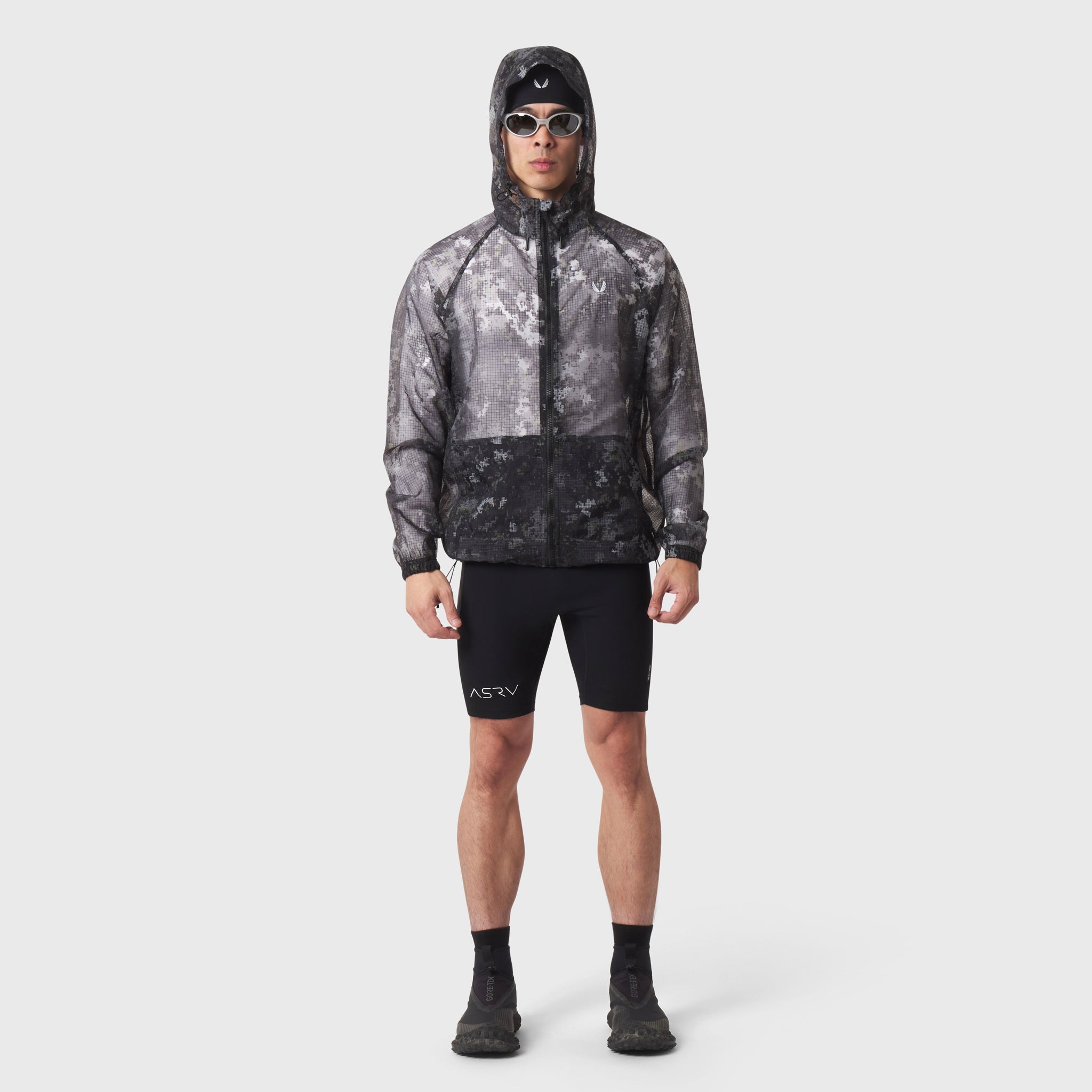 Weather-Ready Transparent Ripstop Shell Jacket in pixel camo, worn by model with hood up