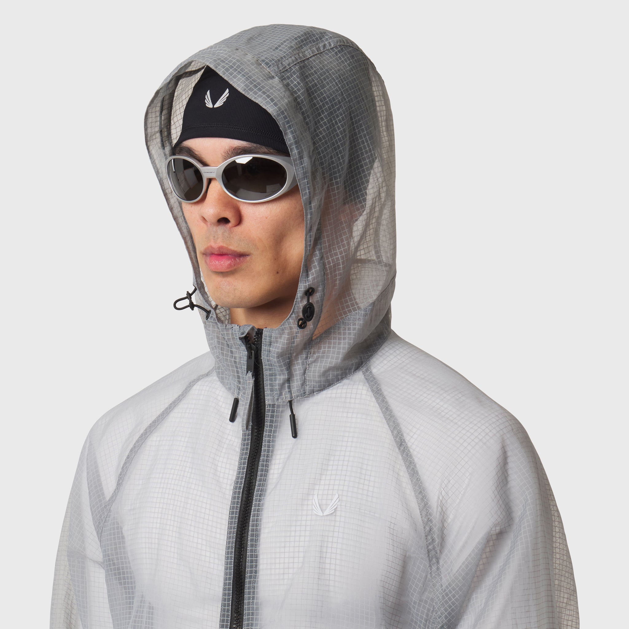 Weather-Ready Transparent Ripstop Shell Jacket in slate grey, worn with hood up and sunglasses