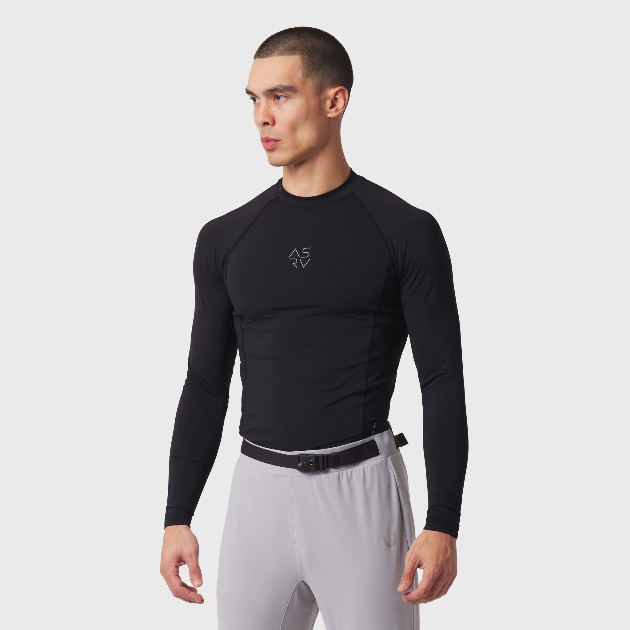 LYCRA® ADAPTIV Baselayer Longsleeve in black, worn by model in side profile pose