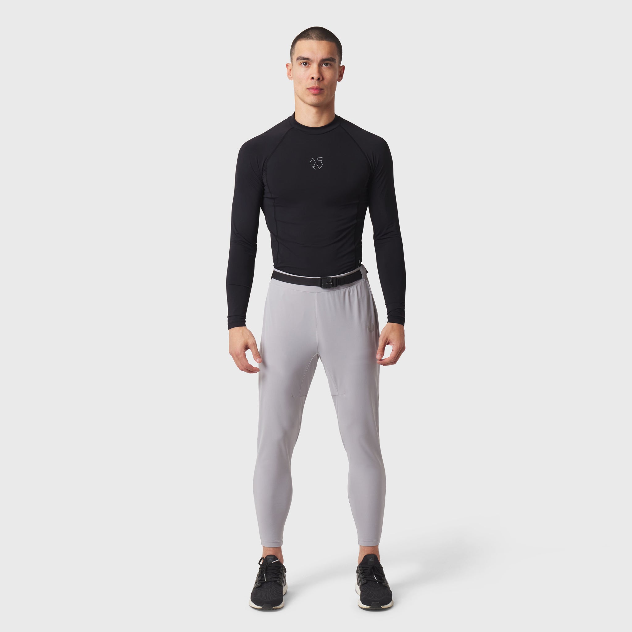 Black LYCRA® ADAPTIV baselayer longsleeve with grey leggings, front view on model