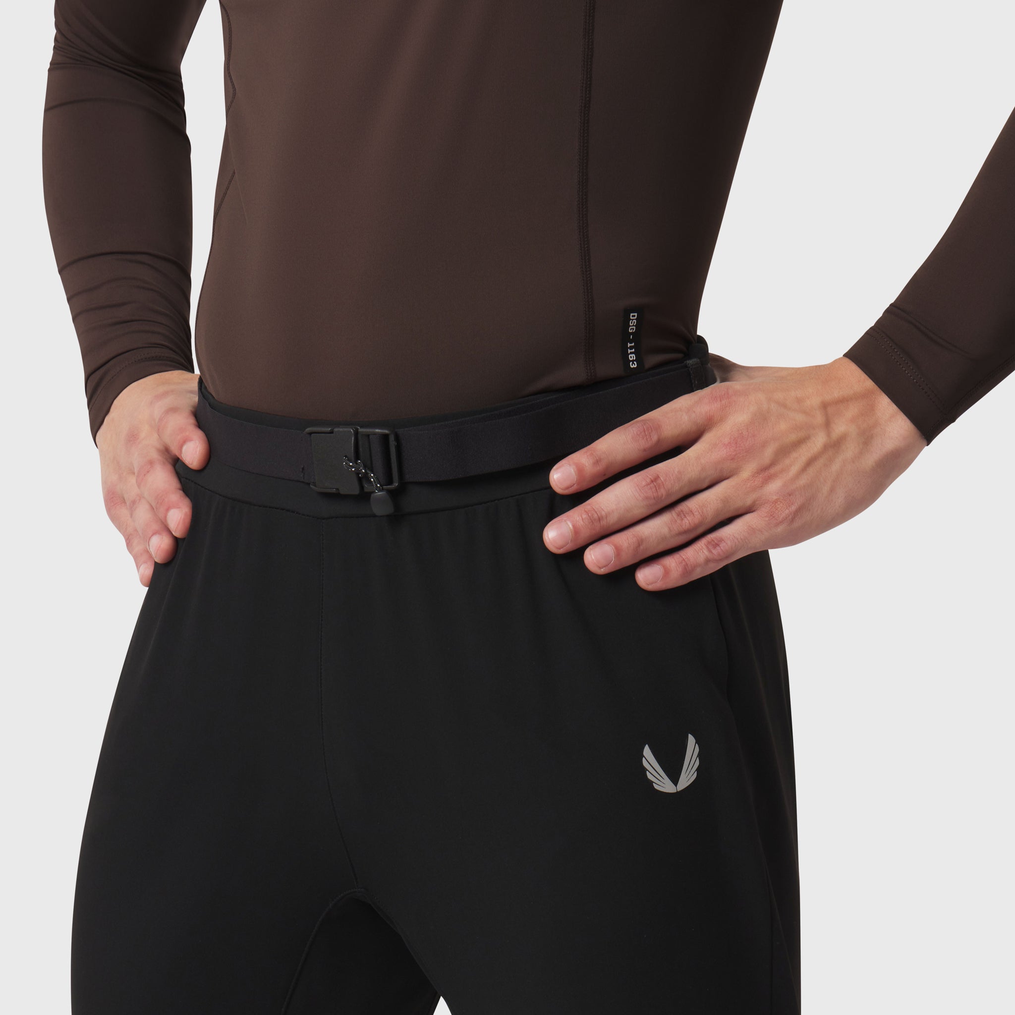 LYCRA® ADAPTIV Baselayer Longsleeve in Dark Earth, worn by model with hands on hips