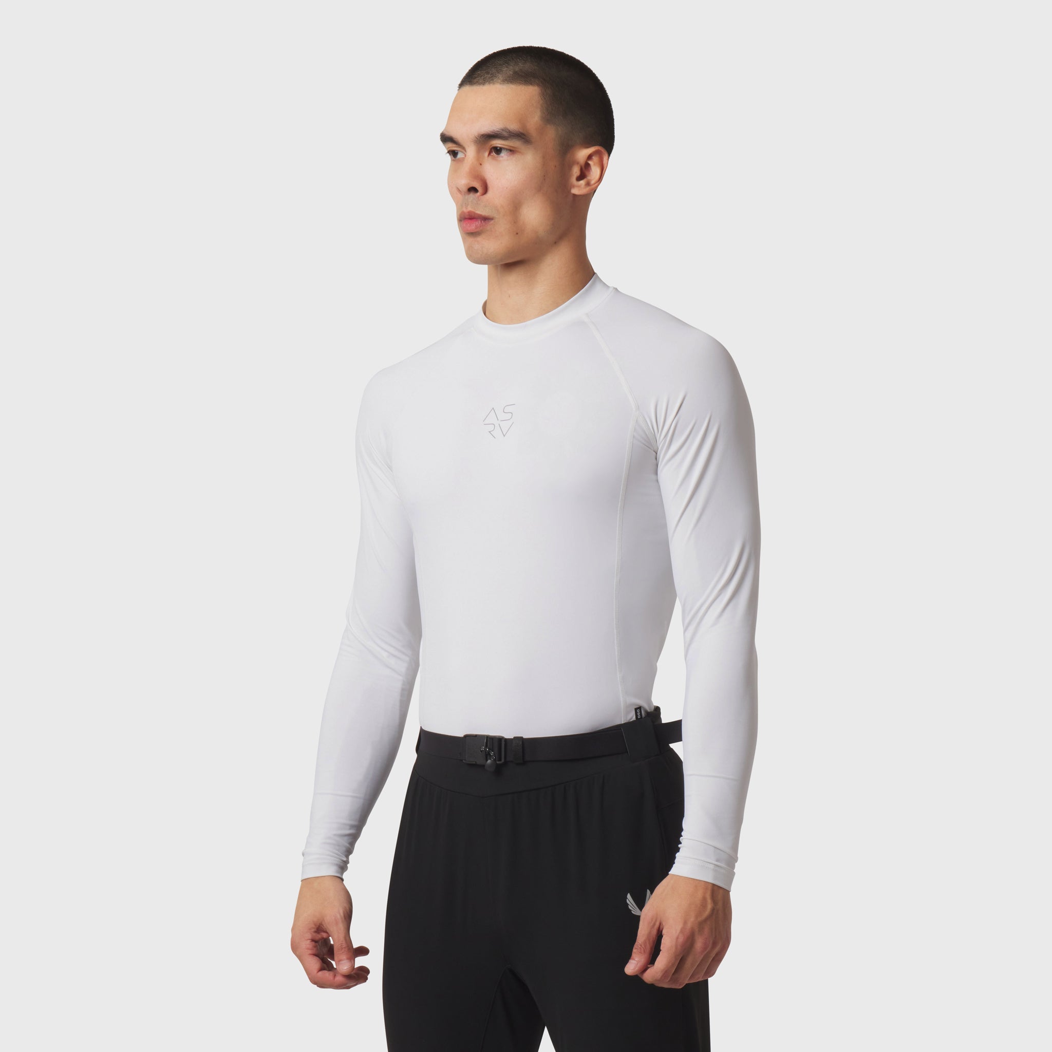 LYCRA® ADAPTIV Baselayer Longsleeve in white, worn by model in side profile stance