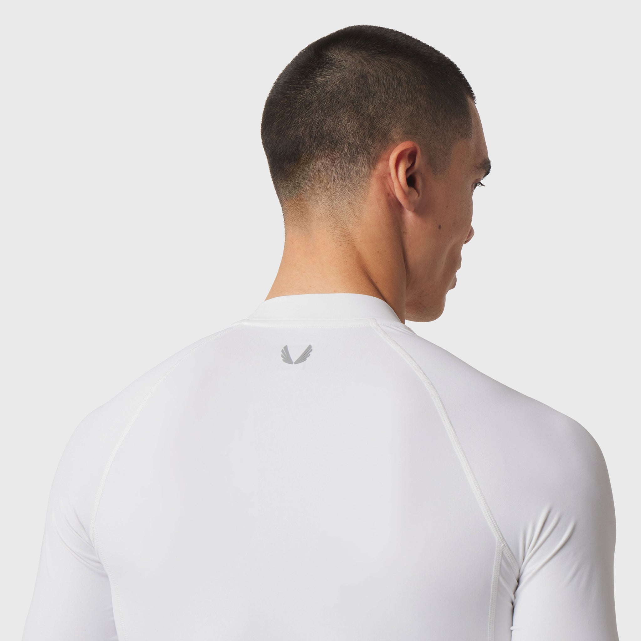 LYCRA® ADAPTIV Baselayer Longsleeve in white, rear view on model