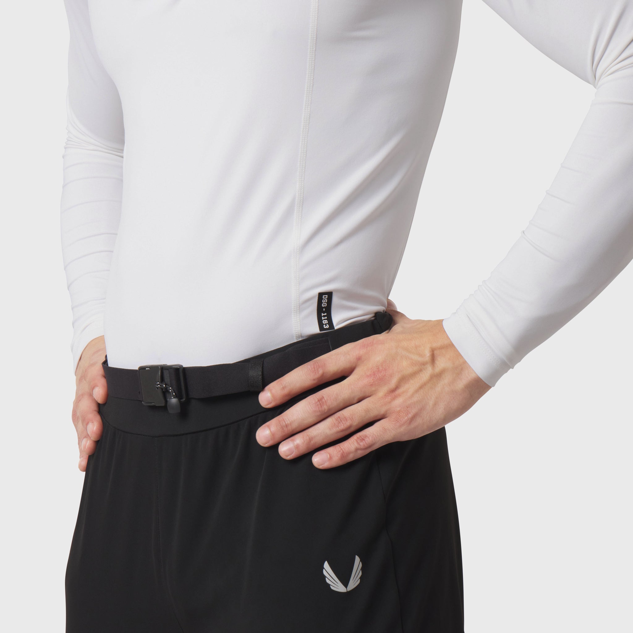 LYCRA® ADAPTIV baselayer longsleeve in white, worn with black pants, front detail