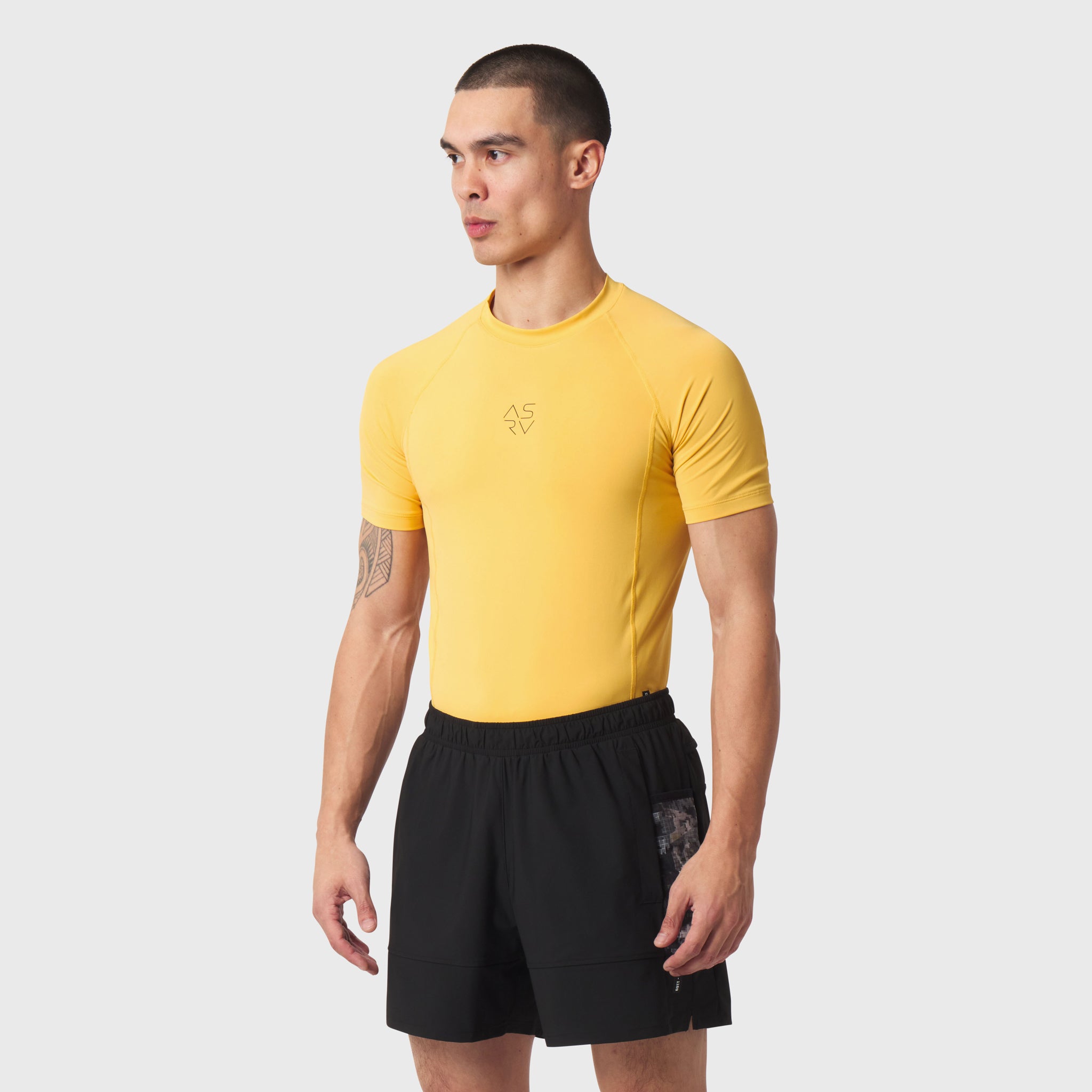 LYCRA® ADAPTIV Baselayer Shortsleeve in amber yellow worn by model, front view