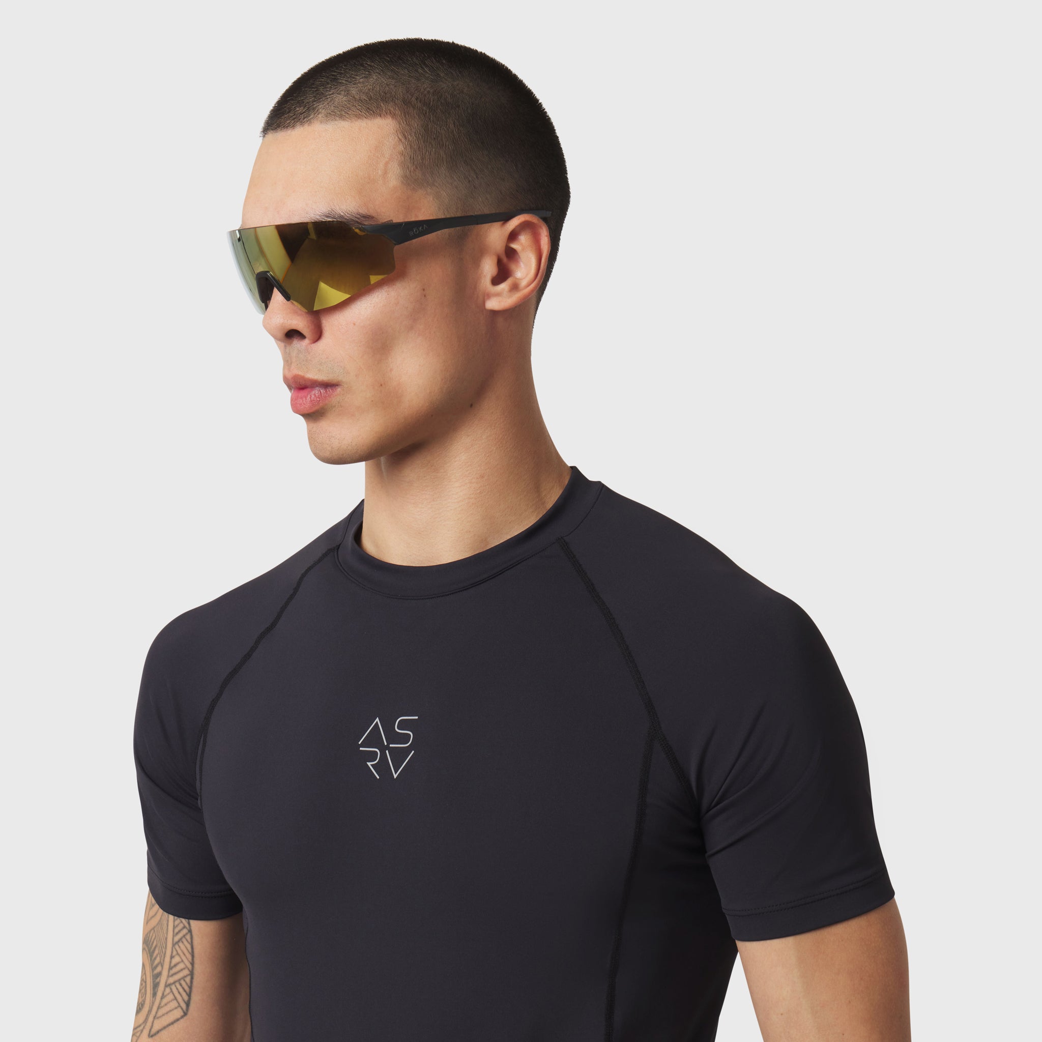 LYCRA® ADAPTIV Baselayer Shortsleeve in black, worn by model in profile view