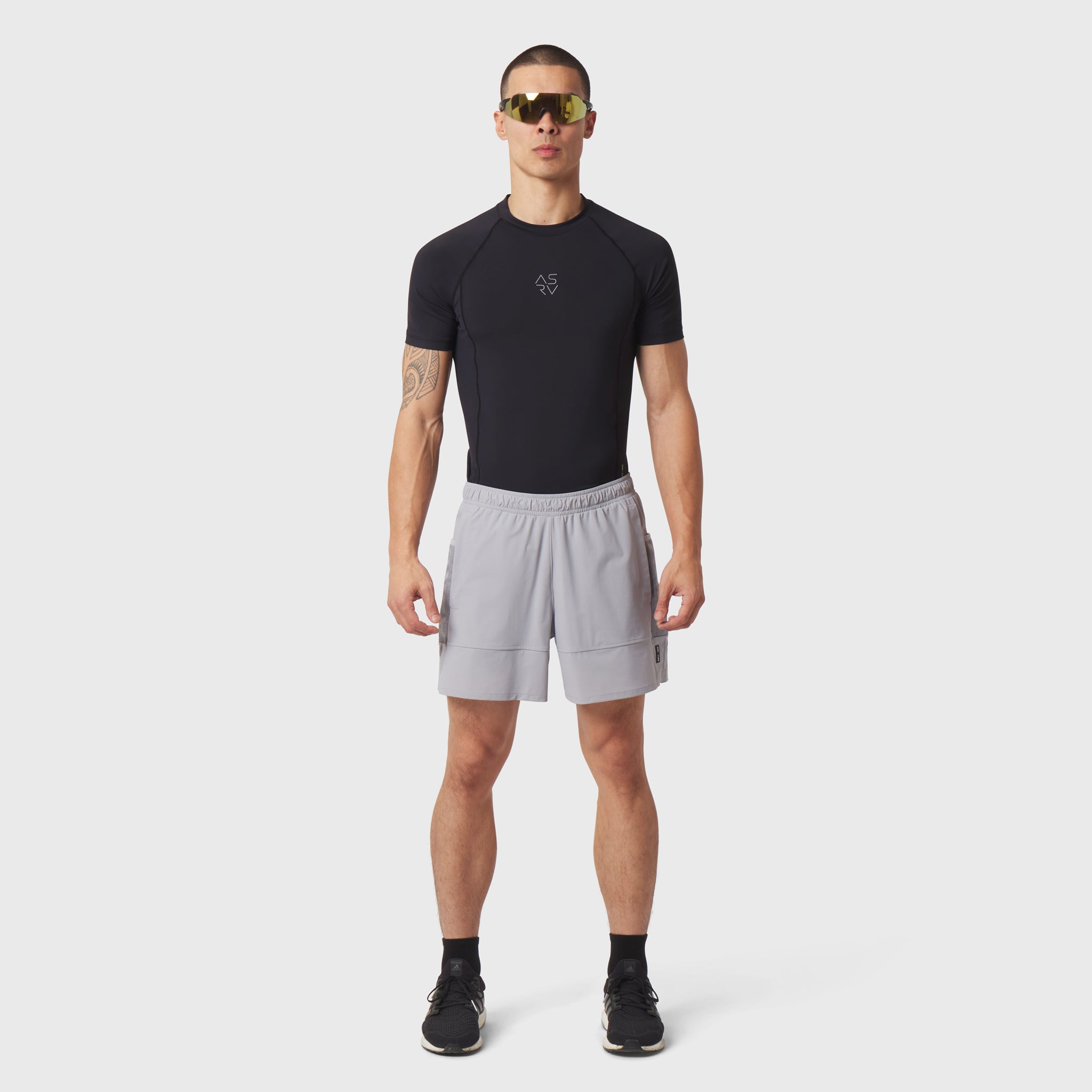 Black LYCRA® ADAPTIV baselayer shortsleeve worn with grey shorts, front view