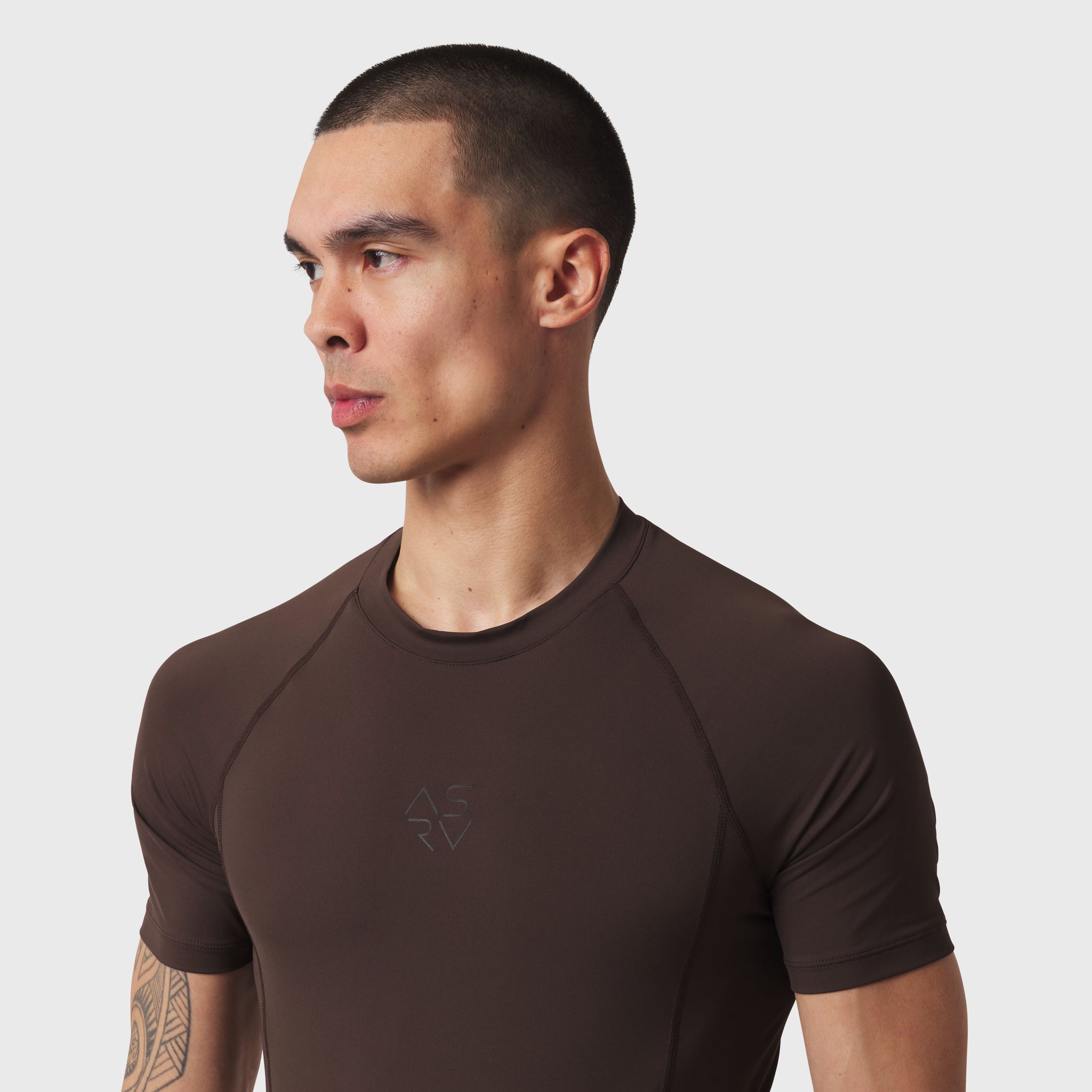 LYCRA® ADAPTIV baselayer short sleeve tee in dark earth, worn by model in profile