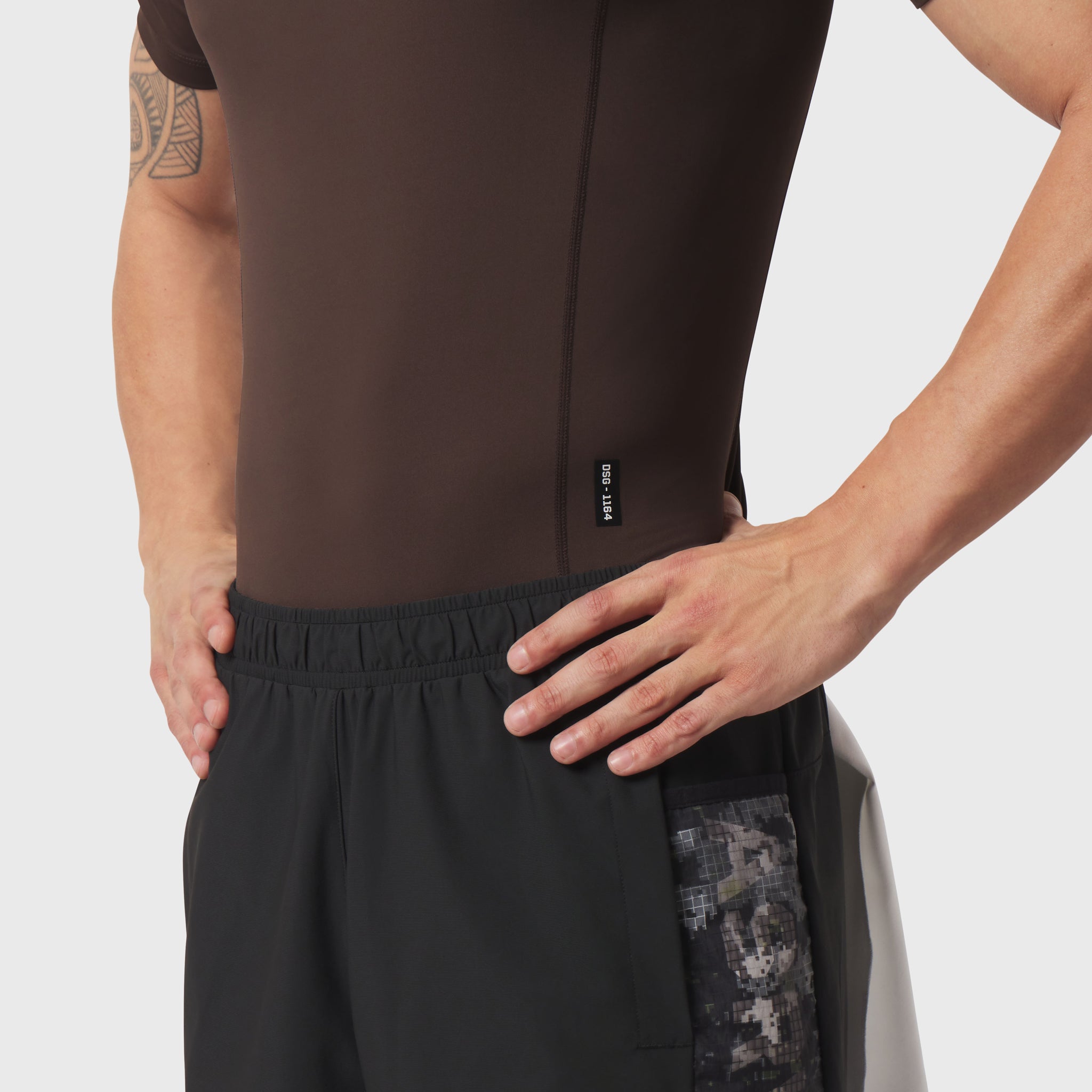 LYCRA® ADAPTIV baselayer shortsleeve in dark earth, worn by model, side view