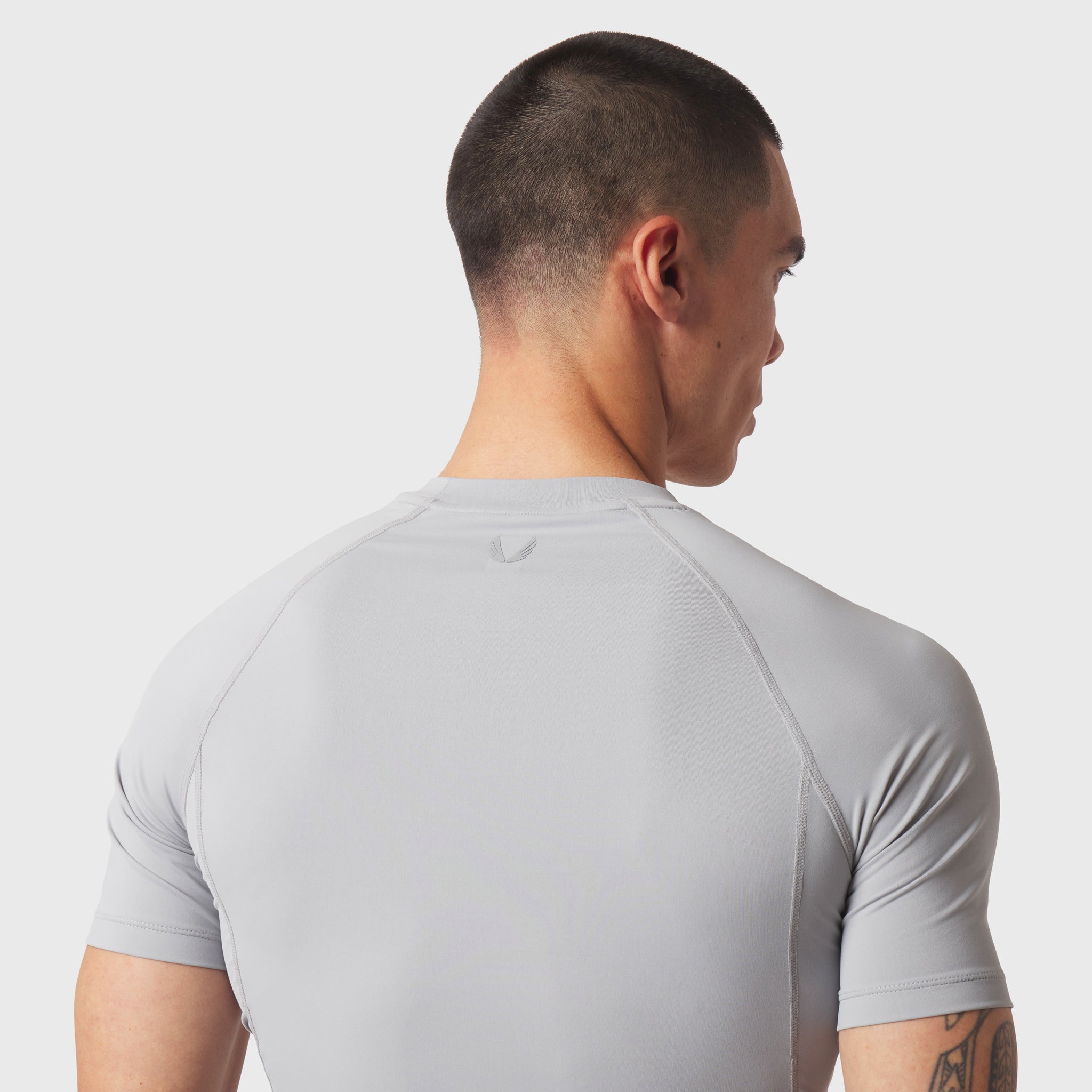 LYCRA® ADAPTIV Baselayer Shortsleeve in slate grey, worn by model, back view